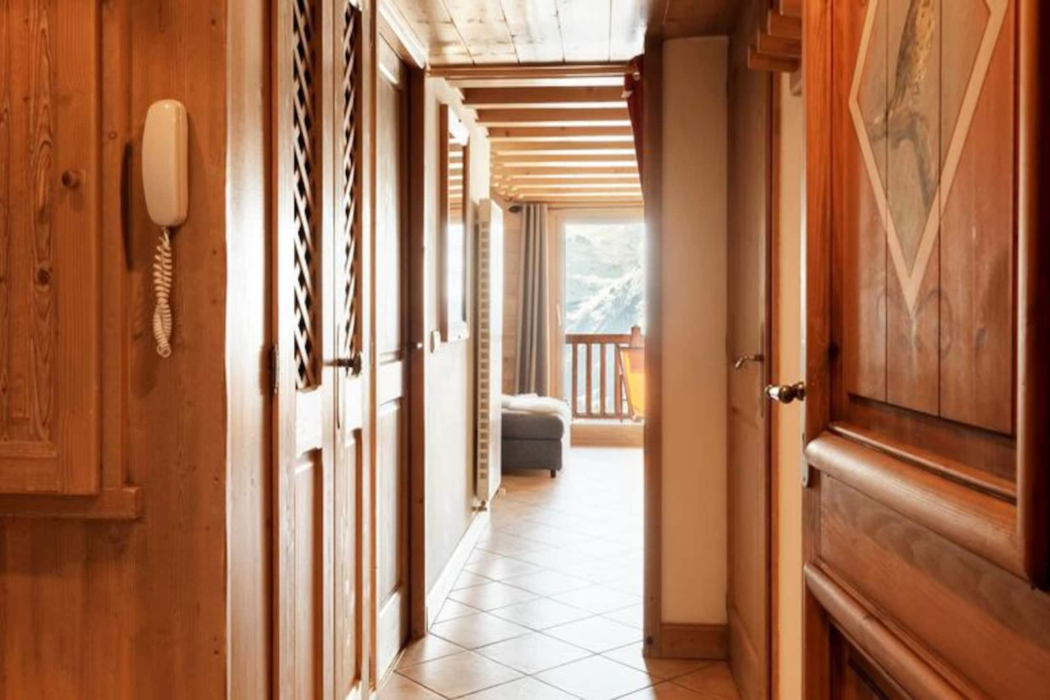 This modern duplex apartment offers three high-end rooms designed for four people, with 70m² of space (58m² under Carrez law). Located on the 3rd floor, this apartment provides a comfortable living space with a bedroom featuring a double bed. The living area is well-equipped with a kitchen offering a ceramic hob, refrigerator, dishwasher, and a combined microwave oven. A south-facing balcony provides breathtaking views of the Haute Tarentaise valley, while an underground parking space is included for convenience. Please note that the property is not pet-friendly, ensuring a serene and allergy-friendly environment for all guests.

Ideal for ski enthusiasts, the apartment offers direct access to the slopes just meters away and provides a return-on-skis option, making it a perfect winter getaway. In addition, the area is close to various local attractions, cafes, and markets, allowing guests to experience the charm of the surrounding region. Whether you’re enjoying a warm drink at a local cafe, shopping for fresh produce at nearby markets, or exploring the beauty of the Haute Tarentaise valley, everything is within easy reach from this ideal location.

The apartment is designed for comfort and convenience, with a modern kitchen and a bathroom with a separate WC. Upstairs, there is an additional bedroom with two single beds and an adjoining shower room. Linen is included, and beds are made upon arrival. The apartment also provides heating for added comfort, along with end-of-stay cleaning included in the booking. Guests can enjoy a hassle-free stay with all essential services taken care of, ensuring a relaxing and memorable vacation.