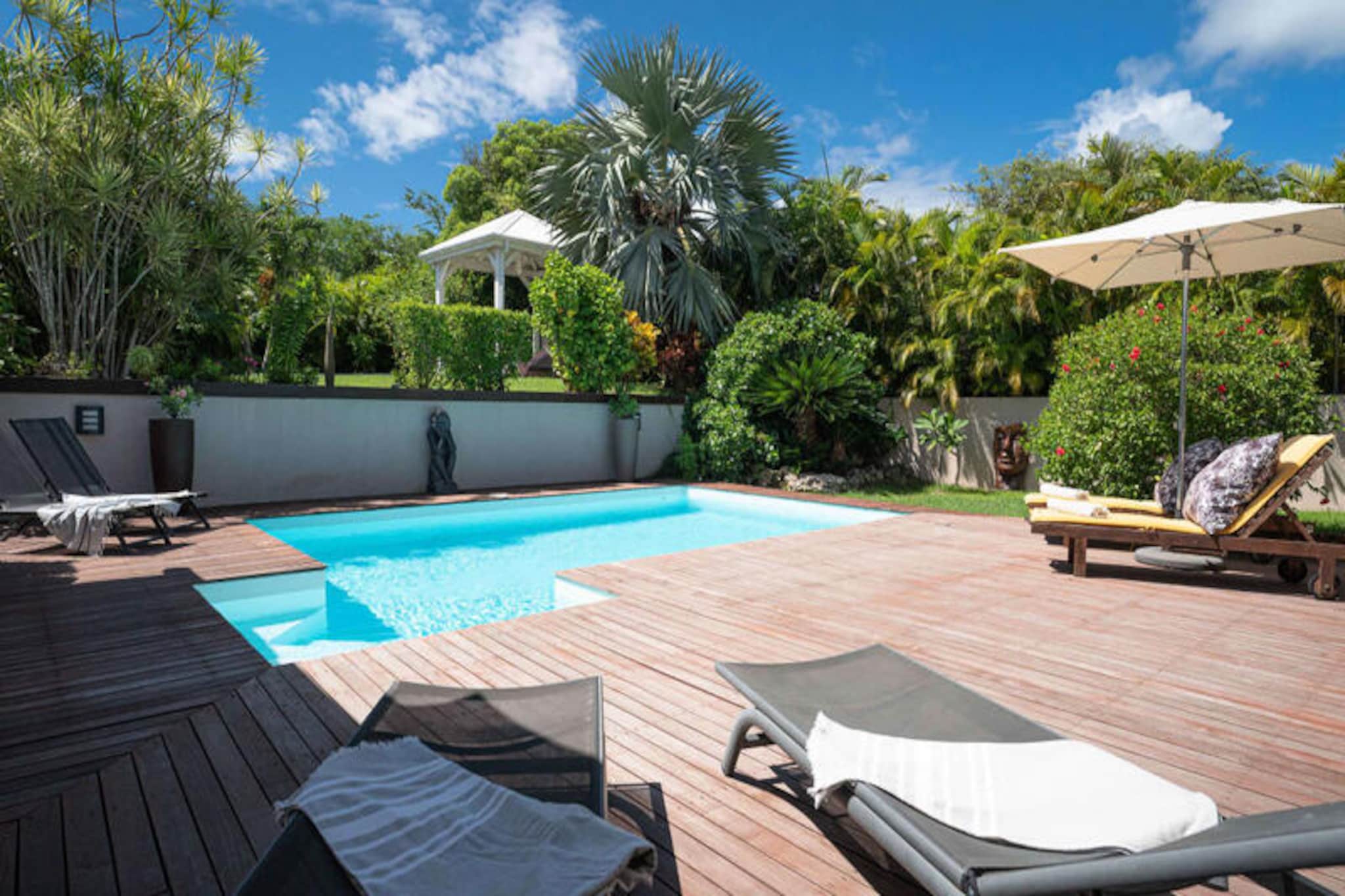 This luxurious holiday home offers four air-conditioned bedrooms with private bathrooms, accommodating up to 8 guests. Bedroom 4 features one 180 cm bed and two 90 cm beds for flexibility. The property includes a private garden, swimming pool, jacuzzi, and spacious terrace with a barbecue and ping pong table. It is pet-free and perfect for families or groups.
Located in Saint-François, the property is just a short walk from the beach and the lively Marina, offering restaurants, boutiques, and leisure activities. The Saint-François Golf Course, Casino, and Aerodrome are also nearby. Water sports enthusiasts can enjoy surf lessons and Wing Foil rides at nearby beaches like Raisins Clairs and Anse-Champagne.
Inside, the home features a fully equipped kitchen with a coffee maker, dishwasher, and all necessary appliances. The large living area opens onto the terrace, providing beautiful garden views. Quality linens and towels are provided, and housekeeping services ensure a hassle-free stay. Additional services like concierge assistance, excursions, and vehicle rentals are available to enhance your vacation experience.