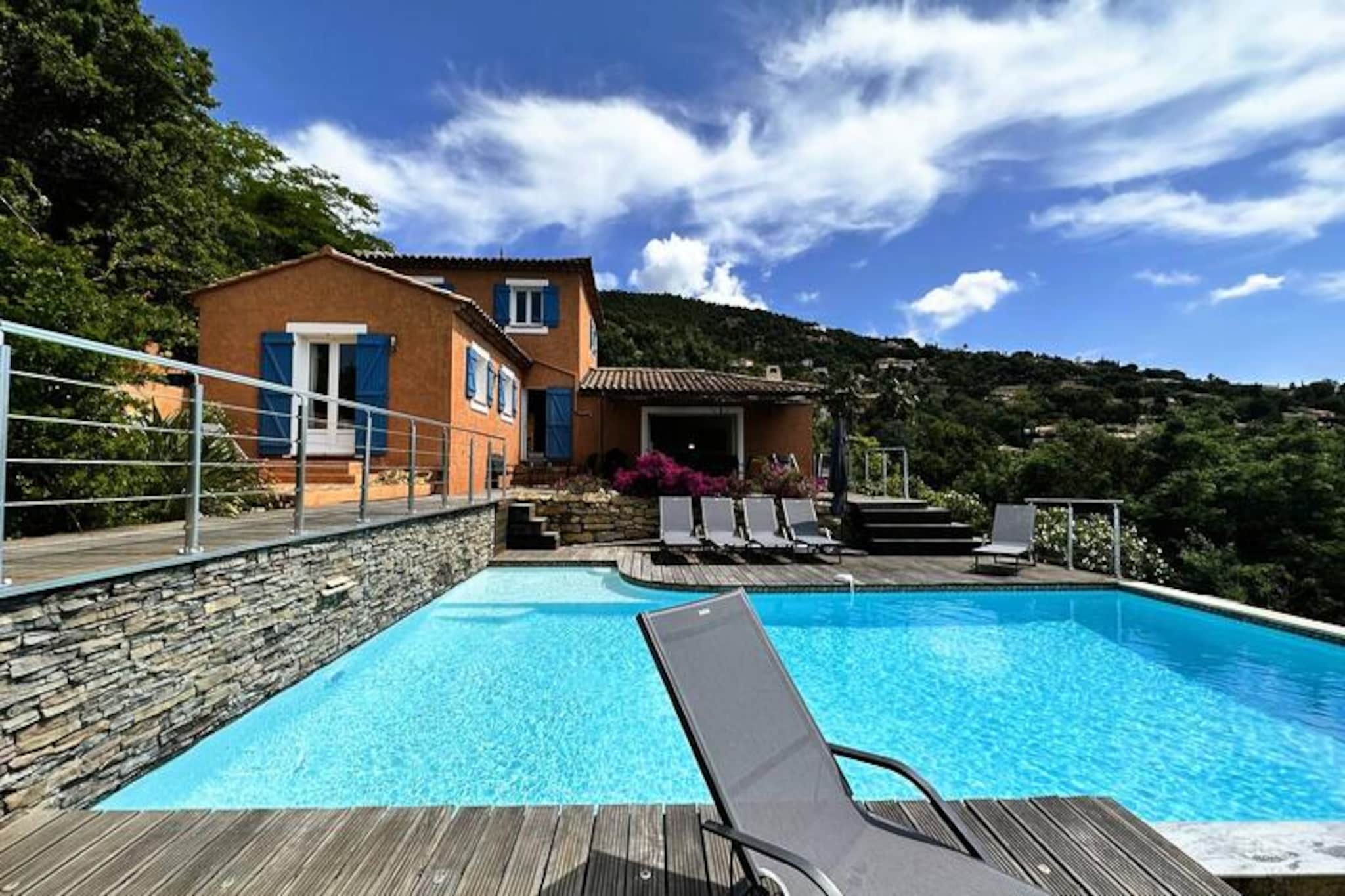 Nestled in the heart of the Maures Massif, this luxurious villa offers an unforgettable escape surrounded by lush green hills and breathtaking sea views. Fully air-conditioned, the property features a spacious living room opening onto wooden terraces and an inviting infinity pool. Accommodating up to ten guests, it includes a master suite with a queen-size bed and private terrace access, two bedrooms upstairs (one double and one twin) sharing a shower room, and an independent annex with two additional bedrooms, each with an en-suite bathroom. This property is non-smoking, not pet-friendly, and unsuitable for young children or individuals with reduced mobility.
Located in the serene Domaine de Valcros, this villa is just a short drive from the pristine sandy beaches of La Londe-les-Maures, with panoramic views of the Golden Islands and surrounding vineyards. Enjoy proximity to an international golf course, fragrant maquis-covered hills, and turquoise Mediterranean waters. Nearby, explore the charming towns of Bormes-les-Mimosas and Hyères or visit bustling markets, seaside cafes, and local attractions.
The villa is designed for ultimate comfort, featuring a fully equipped kitchen with a dishwasher, washing machine, dryer, and electric Weber barbecue. Relax with Wi-Fi, a connected TV, and spacious outdoor terraces perfect for dining or unwinding. On-site parking for two vehicles is included, along with optional linen rentals and end-of-stay cleaning services. Enjoy a tranquil retreat in this stunning hillside haven.