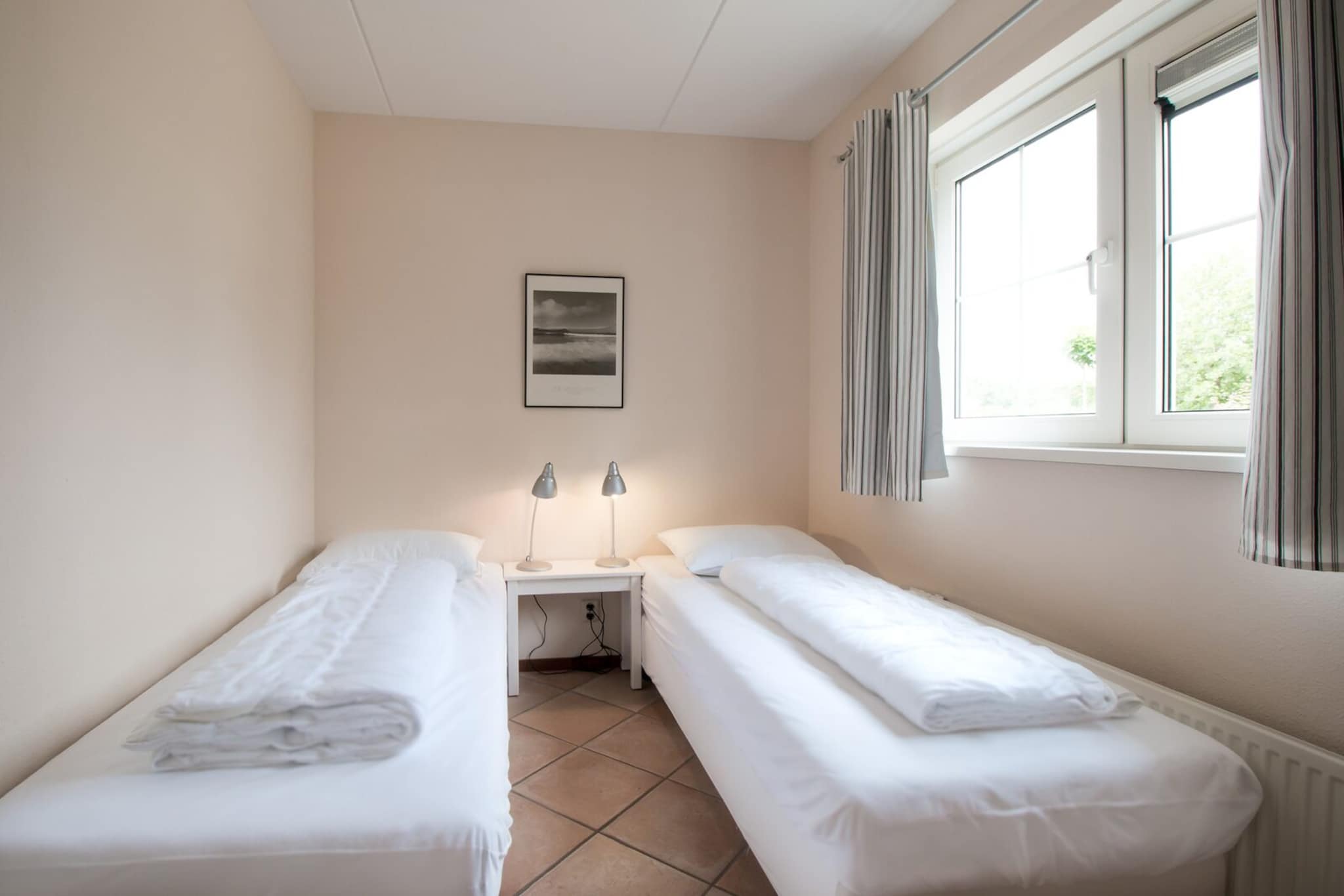 Ground floor: (open kitchen(hob(4 ring stoves, gas), electric kettle, toaster, coffee machine(filter), oven, combination microwave, dishwasher, fridge-freezer, dishes and cutlery, Cooking basics), Living/diningroom(TV(cable, dutch television channels, german television channels), dining table, seating area), bedroom(single bed, single bed), bathroom(shower(walk-in shower), washbasin, toilet))\n\nOn the 1st floor: (bedroom(double bed), bedroom(single bed, single bed), bathroom(shower(walk-in shower), washbasin), toilet(washbasin, toilet))\n\nGarden Furniture , washing machine, patio, heating(central), garden, BBQ, parking, ironing board, iron, Charging post for electric cars