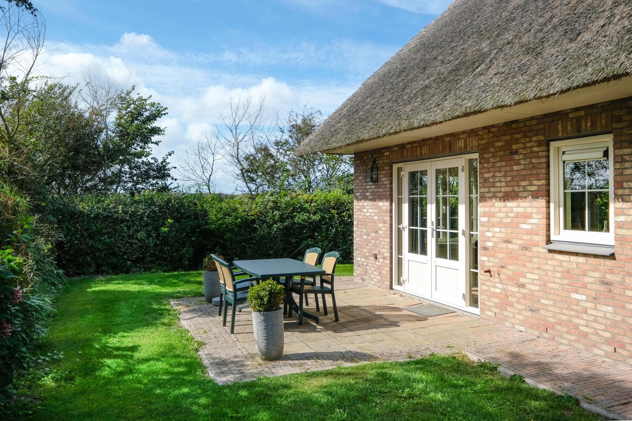 Escape to this peaceful holiday home in the small-scale Villapark Anzelhoef, Sint Maartenszee. Just a 10-minute bike ride to the beach and a short walk to the forest, this property is perfect for a cycling or walking holiday near the sea. The living room is comfortably furnished with two sofas, two armchairs, and a spacious coffee table. A cable TV offers Dutch and German channels. The dining room features a large table with six chairs, and a high chair is available. The open kitchen is fully equipped with a dishwasher, Nespresso and filter coffee makers, a kettle, toaster, gas cooker, and microwave. A washing machine and dryer are available in the utility room.  

This spacious house offers four bedrooms. The ground floor has one bedroom with two single beds, while the first floor has three bedroomsâ€”a double bedroom with a 180x200 cm bed, a twin bedroom with two 90x200 cm beds (including a cot), and a small single bedroom. All beds feature single mattresses and duvets. Please note: while there are seven beds, the house is designed for six guests. 

Step outside into the sunny garden through the living room doors, where a beautifully landscaped terrace awaits, complete with garden furniture. Barbecuing is permitted using gas or electricity, but no charging of electric vehicles is allowed. Parking is available for one car at the property, with additional parking nearby. Free WiFi is included, but linen is not standardâ€”guests are encouraged to bring their own or rent during booking. Pets are not allowed, ensuring a tranquil and allergen-free stay.