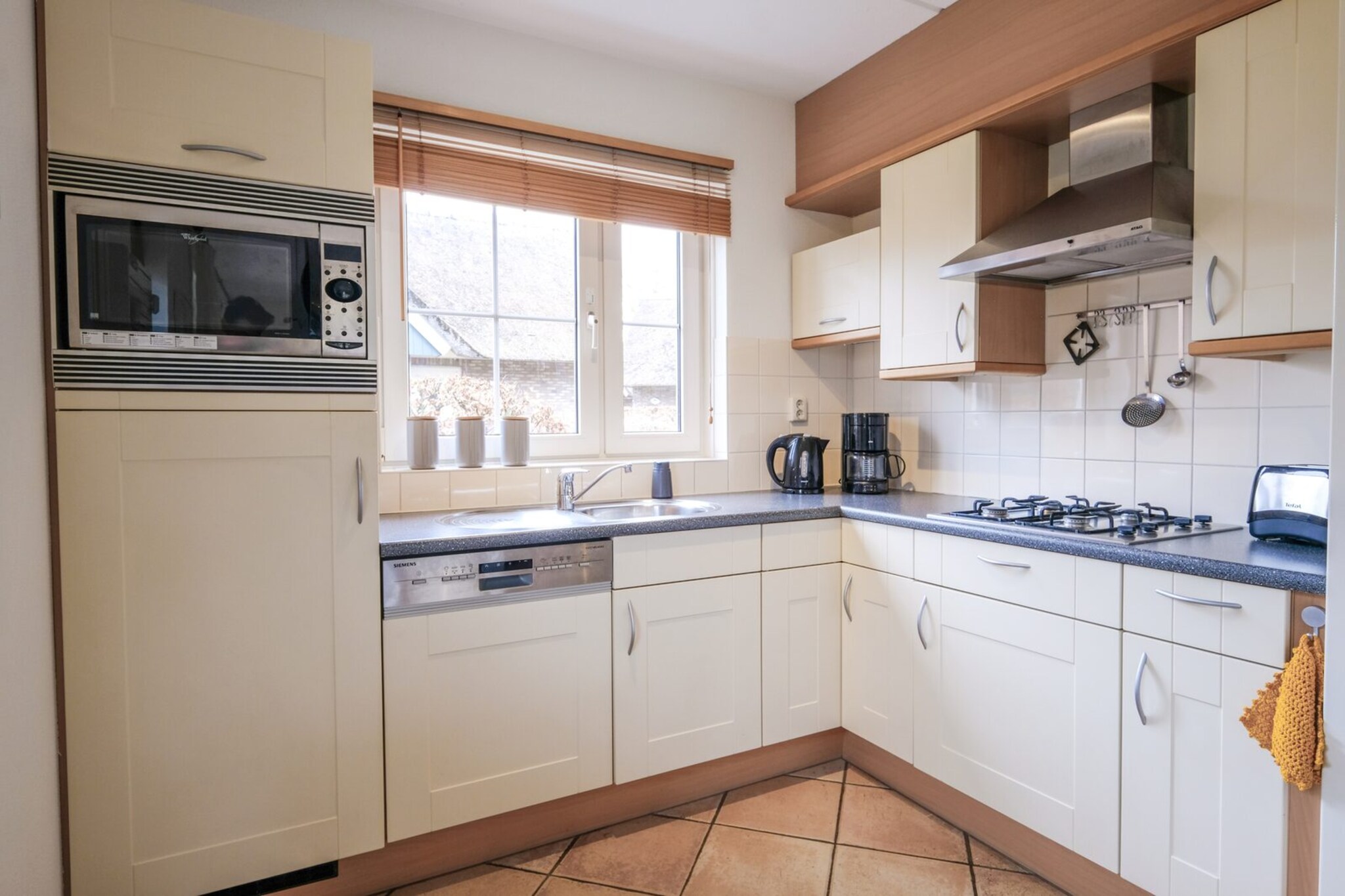 Ground floor: (Living room(TV(cable, flatscreen), seating area), dining room(dining table(6 persons)), open kitchen(stove(gas), electric kettle, toaster, coffee machine(filter), combination microwave, dishwasher), bathroom(shower, washbasin, toilet))\n\nOn the 1st floor: (bedroom(double bed(twin duvet)), bedroom(single bed(duvet), single bed(duvet)), bedroom(single bed(duvet), single bed(duvet)), toilet(toilet))\n\ntumble dryer, cot, washing machine, garden doors, patio, heating(central), terrace, garden, garden furniture, BBQ, parking, high chair, stair gate, Charging post for electric cars