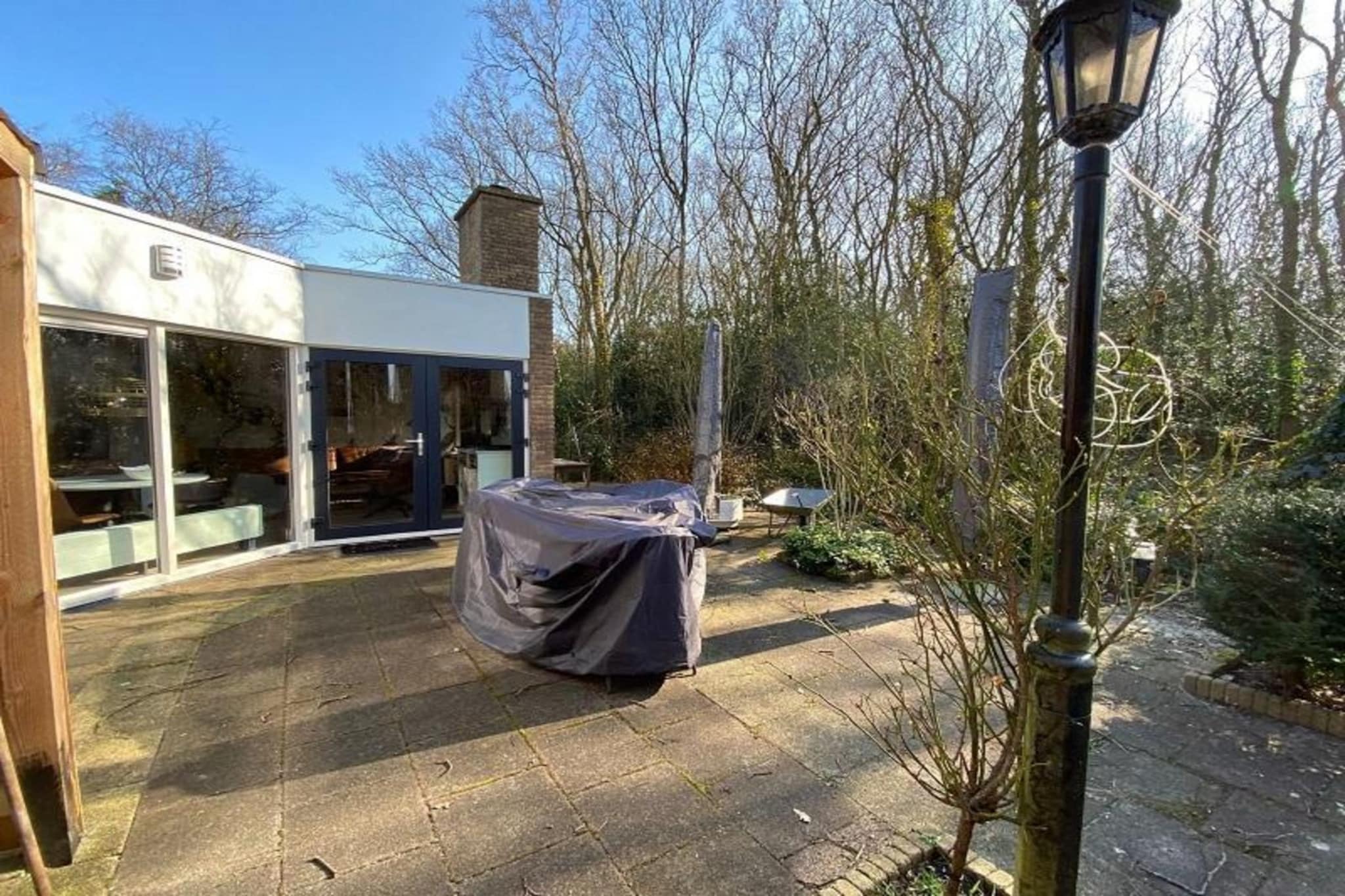 Welcome to this bungalow in peaceful bungalow park located just 2 kilometers from the beautiful sandy beach of Sint Maartenszee. With 13 charming bungalows nestled in a green setting, this retreat is perfect for families, nature lovers, beachgoers, and culture enthusiasts. Recently renovated and tastefully furnished, this cozy bungalow comfortably accommodates five guests, with additional sleeping options on a trundle bed, making it ideal for families with young children.

As you enter, you'll find a warm living room featuring a three-person sofa, two armchairs, and a television with Ziggo cable. Enjoy the cozy atmosphere created by the wood-burning stove, perfect for chilly evenings. The open kitchen is equipped with modern appliances, including an induction hob, dishwasher, combi oven-microwave, and fridge-freezer, along with essential kitchenware and a dining table for five, plus a highchair for little ones. French doors open to a sunny terrace, ideal for outdoor dining and relaxation.

The bungalow offers a master bedroom with two single beds, a second bedroom with a bunk bed, and a third bedroom featuring a single bed with a trundle bed underneath. A modern bathroom includes a walk-in shower and washbasin, while the toilet is separate. Enjoy the tranquil garden terrace surrounded by trees and vibrant bulb fields in spring. Central heating, parking for one car, and a washing machine in a lockable shed add convenience. Please note that pets and smoking are not allowed, and this family-friendly park is reserved for families and couples. Linen is not included but can be rented for â‚¬13 per person per stay.