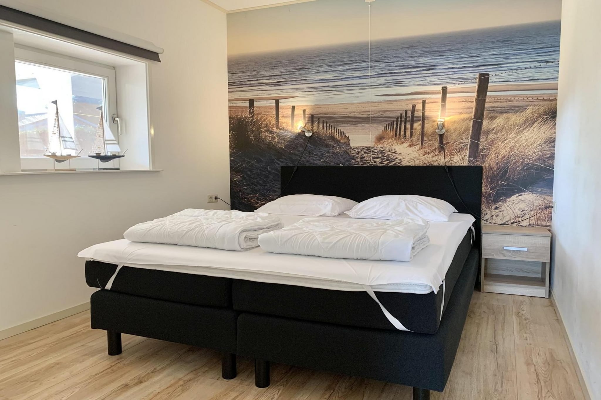 Ground floor: (open kitchen(hob, coffee machine, oven, microwave, dishwasher, fridge-freezer), Living/bed room(TV(digital), dining table, seating area, radio), bedroom(double bed), bedroom(double bed), bedroom(single bed, single bed), bathroom(shower, washbasin), toilet(toilet))\n\nterrace, garden(fenced), garden furniture