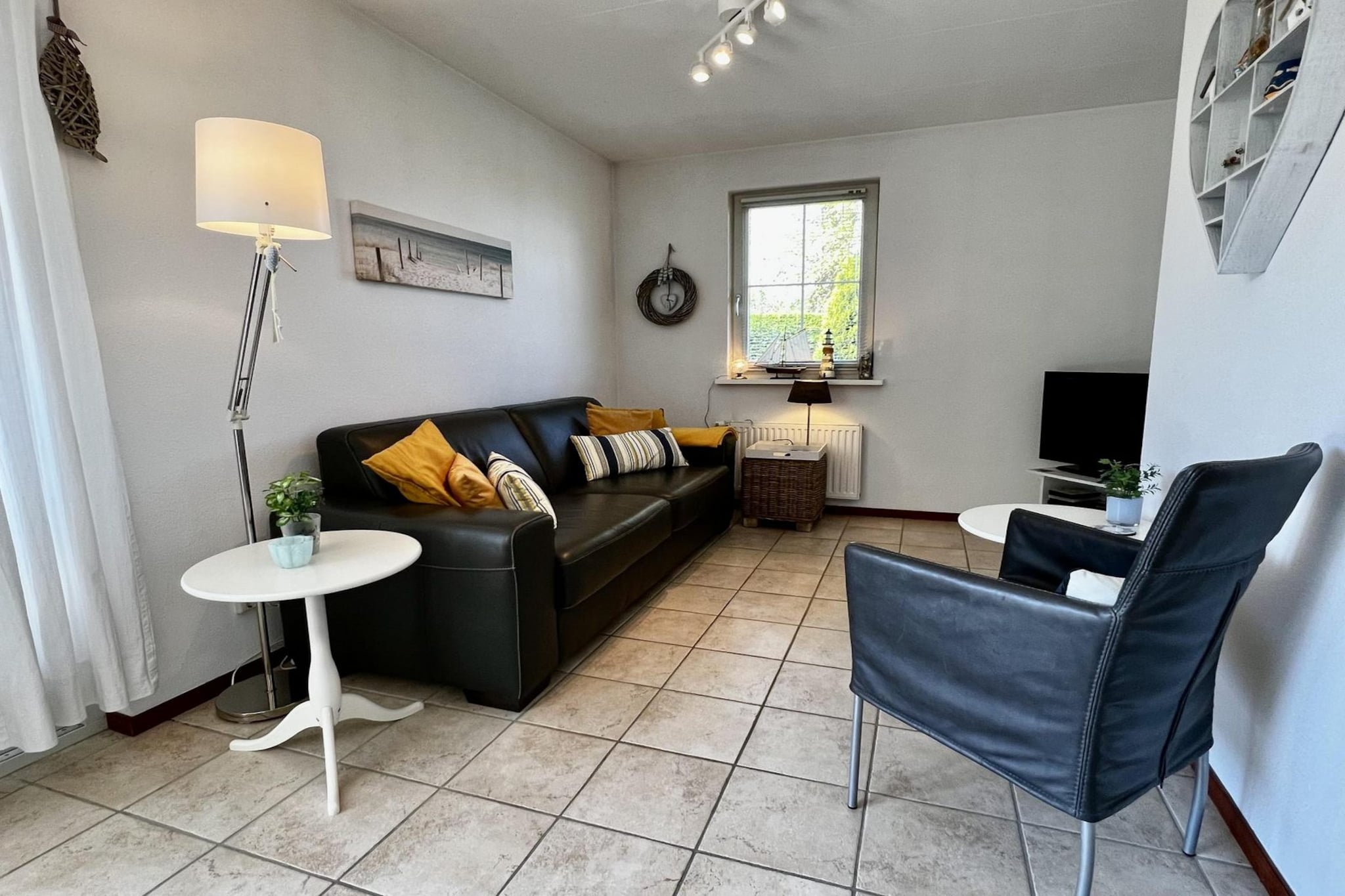 Step into a bright and beautifully styled holiday retreat that captures the spirit of sun, sea, and sand. The fresh, modern dÃ©cor with soft blue and white accents immediately sets the mood for a carefree coastal getaway.

The spacious living area offers a cozy sitting corner with digital TV, DVD player, and radio, as well as a large dining table for shared meals and conversations. The open kitchen is fully equipped with everything you needâ€”dishwasher, microwave, oven, four-burner stove, Senseo coffee maker, and fridgeâ€”plus the convenience of a washing machine, making longer stays effortless. Two comfortable bedrooms provide restful nights for the whole family. The master bedroom features two single box-spring beds with a large double duvet, while the second bedroom offers a single bed and a bunk bedâ€”perfect for children or friends. A modern bathroom with shower, sink, and fresh ventilation, along with a separate toilet, ensures practicality and comfort.

Outside, a sunny terrace and enclosed garden invite you to relax in complete privacy. Surrounded by hedges, this outdoor space feels like a private haven, ideal for morning coffee, lazy afternoons, or dinners under the open sky. Parking for two cars, underfloor heating, central heating, and Wi-Fi complete the picture of a well-equipped and welcoming home.

With its cheerful atmosphere, thoughtful comforts, and peaceful setting, this holiday spot is the perfect place to unwind and enjoy time by the coast.

The bed-linen is optional and available for â‚¬ 13 p.p./Stay.