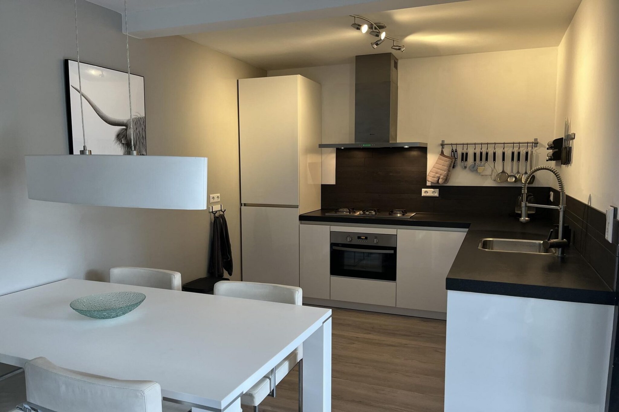 Ground floor: (Living room(TV(smart TV, dutch television channels, german television channels), seating area), open kitchen(dining table, stove, electric kettle, hood, coffee machine(filter), combination microwave, dishwasher, fridge-freezer), bathroom(shower, washbasin, toilet))\n\nOn the 1st floor: (bedroom(double bed), bedroom(single sofa bed, bunk bed))\n\ncot, terrace, garden, bicycle storage, parking, high chair