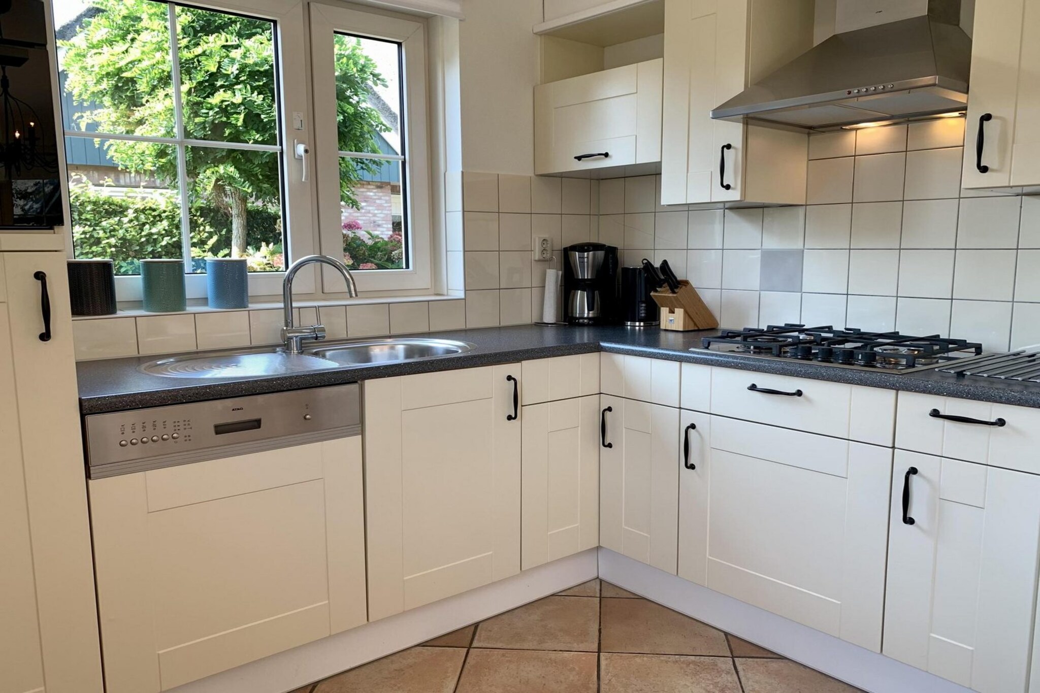 Ground floor: (open kitchen(hob(4 ring stoves, gas), electric kettle, toaster, coffee machine(filter), combination microwave, dishwasher, fridge-freezer, dishes and cutlery, Cooking basics), Living/diningroom(TV(cable, dutch television channels, german television channels), dining table, seating area), bedroom(single bed(70 x 200 cm), single bed(70 x 200 cm)), bathroom(shower(walk-in shower), washbasin, toilet))\n\nOn the 1st floor: (bedroom(double bed(160 x 200 cm)), bedroom(double bed(160 x 200 cm)), bathroom(shower(walk-in shower), washbasin), toilet(washbasin, toilet))\n\nGarden Furniture , washing machine, patio, heating(central), garden, parking, Charging post for electric cars