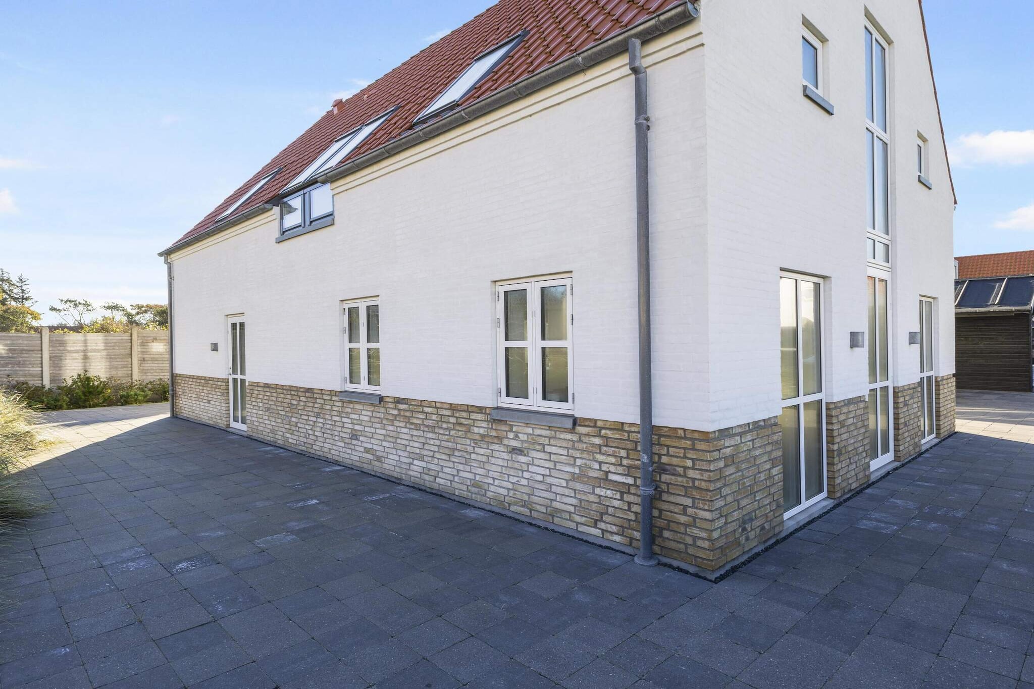 Located just steps away from the charming town of Løkken and one of Denmark’s best beaches, Josefines Have 105 is a spacious and modern holiday home designed for comfort and convenience. The property features three bedrooms and can accommodate up to 10 guests with additional sofa beds. Spread across two floors, the house includes two living rooms, two bathrooms (one with a bathtub), and a well-equipped kitchen with induction cooktops, built-in oven, microwave, and dishwasher. It also offers plenty of entertainment with board games, foosball, and darts, plus a TV in the annex for gaming consoles.
The house boasts multiple sunny terraces, perfect for dining or relaxing in the warmth of the sun throughout the day. With Wi-Fi, a washing machine, dryer, and passive cooling ventilation, all your needs are catered to for a comfortable stay. Within just 200 meters, you’ll find shops, tourist information, and electric car charging stations. The lively town of Løkken and the beautiful beach are only a short walk away, making it a prime location for both relaxation and exploration.
Surrounding the house are lovely terrace areas where you can grill and enjoy the outdoors. The beach is just 700 meters away, and the town offers easy access to shopping, dining, and public transport within a 500-meter radius. Additionally, there are local attractions like the swimming pool, fitness center, and Løkken Miniby nearby, providing even more options for entertainment and relaxation. Despite its central location, the house offers a peaceful and private retreat, ensuring a perfect holiday experience in Løkken.
A refundable deposit might be charged closer to your check-in date. This deposit covers utilities consumed during your stay and any additional services that may be taken. The final amount will be adjusted based on actual meter readings, actual usage of extra services, and any remaining balance will be refunded within 21 days after checkout.