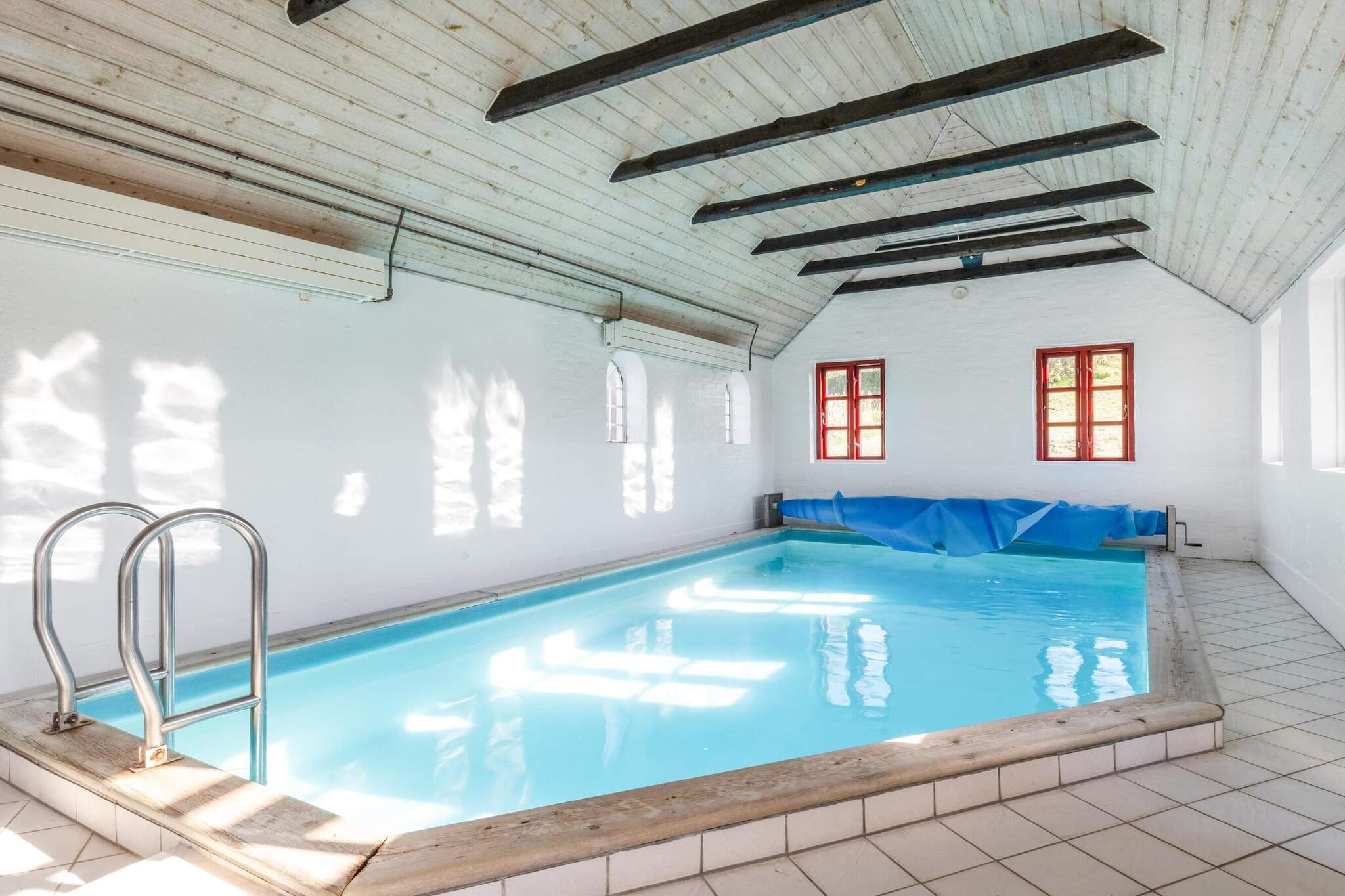 Møllehuset in Blokhus is a unique holiday home spread across four buildings, offering space and comfort for up to 16 guests. Set in a quiet cul-de-sac, just 1 kilometre from the beach, this charming property is ideal for multiple families or groups of friends looking to enjoy a memorable Danish holiday. The property includes a pool house with a large pool, sauna, and bathing facilities, ensuring a convenient and relaxing experience. The other three buildings feature separate kitchens, shower facilities, and ample living space, making this an ideal choice for group stays. With Blokhus' shops, restaurants, and attractions such as the beach, Fun Art, and Fårup Sommerland nearby, this location offers everything for an active or relaxing holiday. Enjoy walking or cycling through picturesque paths, or visit nearby Løkken for more sights and activities. The house is situated on a large 3000 square metre plot, ensuring plenty of space for outdoor enjoyment. With a variety of nearby attractions and comfortable living spaces, Møllehuset provides the perfect setting for an unforgettable getaway. The main house, beautifully renovated in 1999, and a two-storey house, recently updated in 2020/2021, provide a total of 392 square metres of space. The house layout includes 8 people in the first house (3 bedrooms), 4 people in the second house (2 bedrooms), and 4 single beds in the annex. The secluded outdoor areas feature spacious terraces, a large garden, and a peaceful environment with nature at your doorstep. The property is perfect for large gatherings, offering both privacy and social spaces.