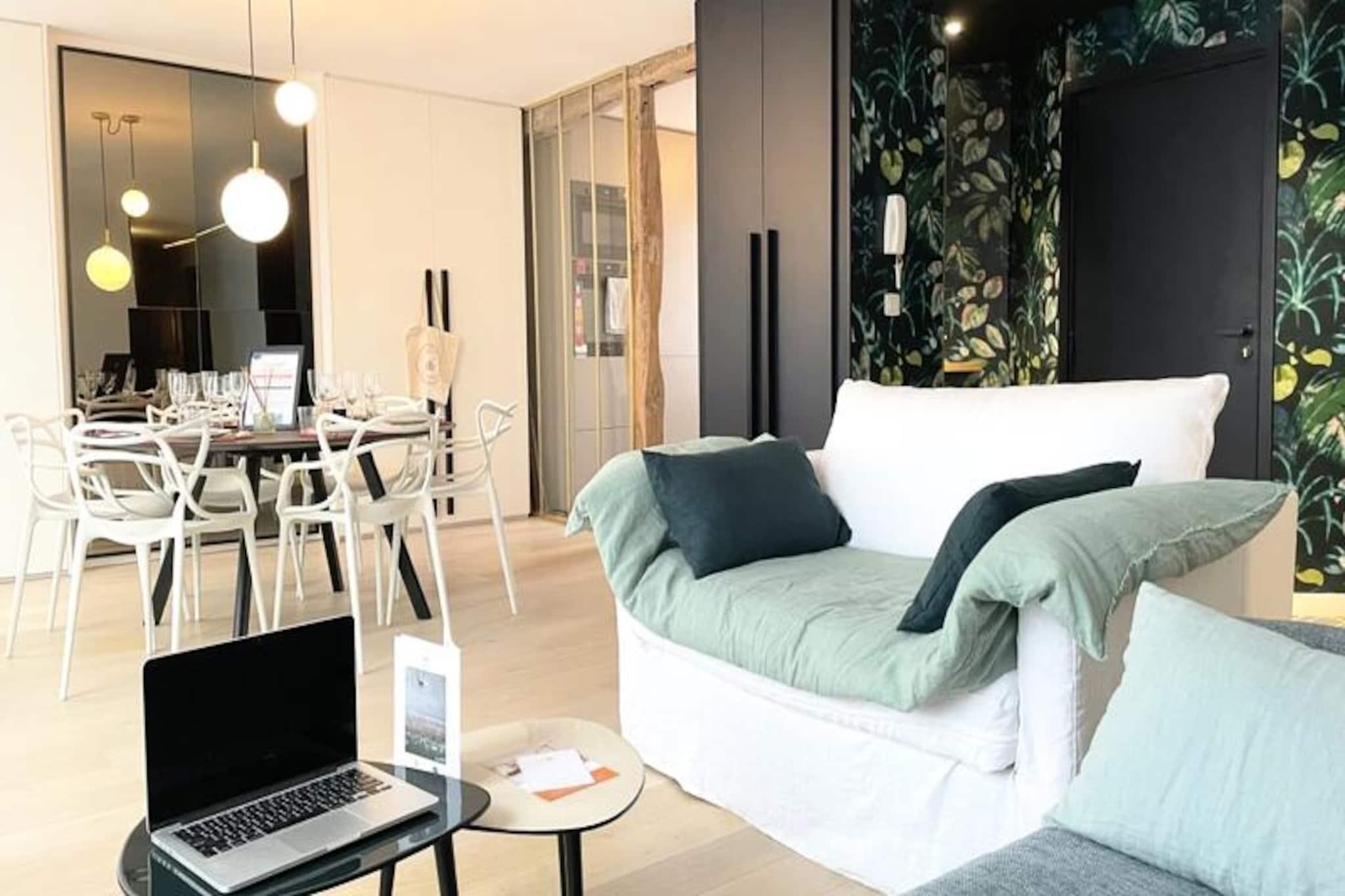 This contemporary apartment comfortably accommodates up to four guests. It features a master suite with a queen-size bed and a second bedroom with two single beds (which can be combined into a double). Bed and bath linens are provided for your convenience. The apartment description does not mention whether pets are allowed, so it's best to inquire directly with the host.
Located in the heart of Rouen, the apartment is just a short walk from the SNCF train station and the famous Place du Vieux Marché. Its central location provides easy access to numerous shops, restaurants, and cultural attractions. The iconic Gros Horloge (Great Clock) is less than a 5-minute walk away, making it an ideal base for exploring the city's historical and cultural heritage.
The apartment offers a fully equipped American-style kitchen with modern appliances, including a fridge, oven, induction hob, dishwasher, and Nespresso machine. A spacious living room provides ample space for relaxation and dining. The master suite features a large dressing room and an Italian-style shower. A washing machine and free WiFi are also available. Please note that parking is not provided, but public parking is available nearby.
