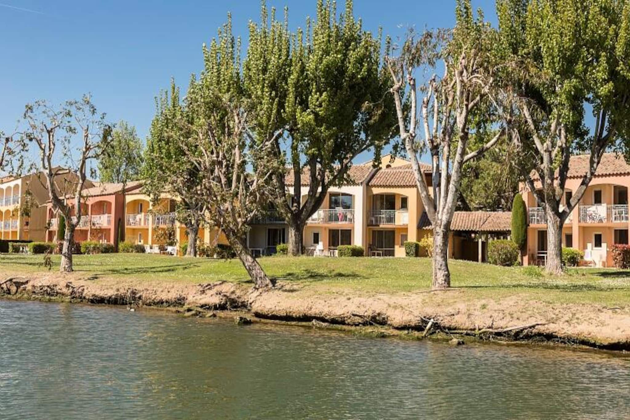 Located just 800 meters from the beach on a picturesque peninsula formed by the Siagne River, the residence offers a charming and tranquil environment. Comprising several small buildings, the residence's regional architectural style blends seamlessly into the lush 5-hectare park, with multi-colored shutters adding to the Mediterranean ambiance. The residence offers a variety of amenities for relaxation and enjoyment, including an outdoor swimming pool, paddling pool, and fitness room (available for an additional fee). You can also dine at the on-site Riviera restaurant or enjoy access to the private pontoon for boat rides.
Nearby, you'll have the opportunity to obtain a boat license in just three days (subject to approval and advance booking) and rent a boat for a seaside excursion. Please note that pets from the 1st and 2nd categories are not allowed. The accommodation features a living room with two sofa beds, one with a trundle bed, a fully equipped kitchen, a bedroom with a double bed, a bathroom with a bathtub, and a toilet.
The apartment, located on the ground floor, includes air conditioning, a furnished terrace, WiFi, a DVD player, and a TV. Baby kits are available upon request (subject to availability), and parking spaces are provided for an additional fee. End-of-stay cleaning is mandatory and must be paid upon arrival. The residence also offers a swimming pool open from April to November, along with other services like bed linen and towels (extra charges may apply). A tourist tax will be payable through your personal account.