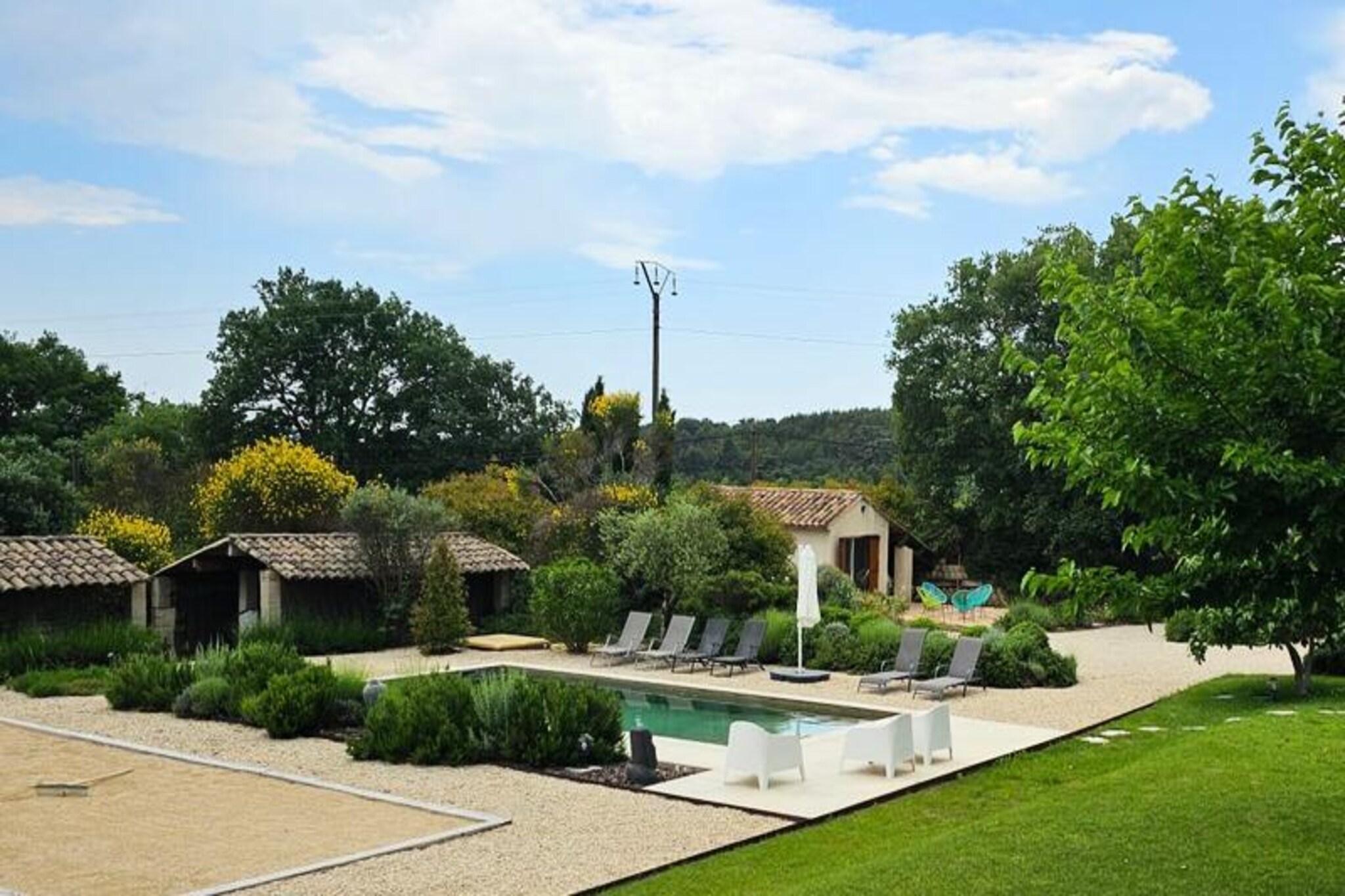 Nestled at the foot of the vineyards, this charming vacation home offers a unique blend of rustic charm and modern comfort. With 3 bedrooms, 4 bathrooms, and a private swimming pool, it promises a peaceful and relaxing stay for up to 6 people. The property is set within the picturesque landscape of the Fontenille wine estate, providing breathtaking views of the vineyards. Enjoy the serene atmosphere as you relax by the pool, savor alfresco meals on the terrace, or explore the beautiful surroundings.
Located on 1,400 m² of land, the house spans approximately 120 m² of living space, complemented by an additional 20 m² outbuilding. The ground floor features a spacious living room with air conditioning, a kitchen, and a small dining area, along with a bedroom and bathroom. Upstairs, another bedroom with an adjoining bathroom awaits, while the outbuilding offers a private bedroom with an additional bathroom. The living room, equipped with air conditioning, ensures comfort during your stay.
For your convenience, the property includes a 9x4 meter swimming pool with a shallow end for relaxing dips and a gas barbecue for outdoor cooking. The house is surrounded by vineyards, offering ultimate privacy and tranquility. With a fenced yard and wrought iron gate, you can enjoy the beauty of Provence in complete peace. Additionally, a private concierge service is available to tailor your stay to your needs, ensuring a memorable and effortless experience.