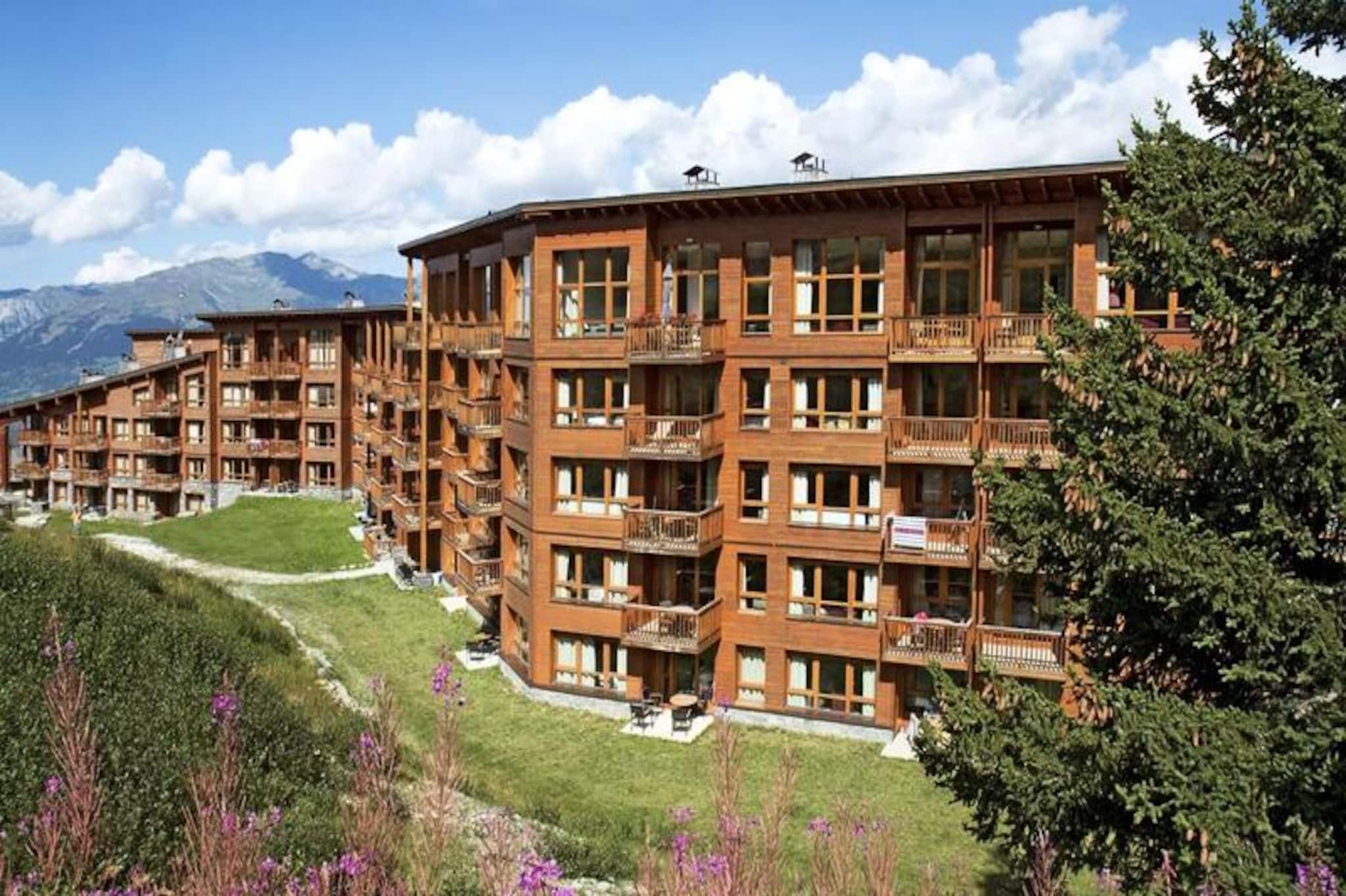Situated in a prime location with stunning views of Mont Blanc and the Tarentaise Valley, this prestigious Appart'hotel offers a unique retreat for nature lovers seeking both relaxation and outdoor activities. Nestled on the edge of the forest, the property is a peaceful haven, away from the bustle of the resort center. The luxury and contemporary design of the accommodation blend seamlessly with the traditional alpine surroundings, ensuring a serene atmosphere for your stay.

Guests have access to the luxurious amenities of the nearby Résidence Edenarc, including a heated indoor pool with a paddling pool, an outdoor pool connected to the indoor pool, a sauna, hammam, jacuzzi, fitness room, and a relaxing lounge area. Additionally, the resort's restaurant offers a great dining experience. This idyllic environment provides the perfect setting for both leisure and relaxation in the mountains.

Each apartment is equipped with a kitchenette, a double bed, and a single sofa bed, making it ideal for up to three people. The room also includes a balcony or terrace, a bathroom with shower or bathtub, and a WC. Free Wi-Fi is available in both the apartments and the lobby. Other amenities include included bed and bathroom linen, daily cleaning (excluding kitchen area), and access to a baby kit upon request. The property also offers covered parking for an additional charge, ensuring a convenient stay.