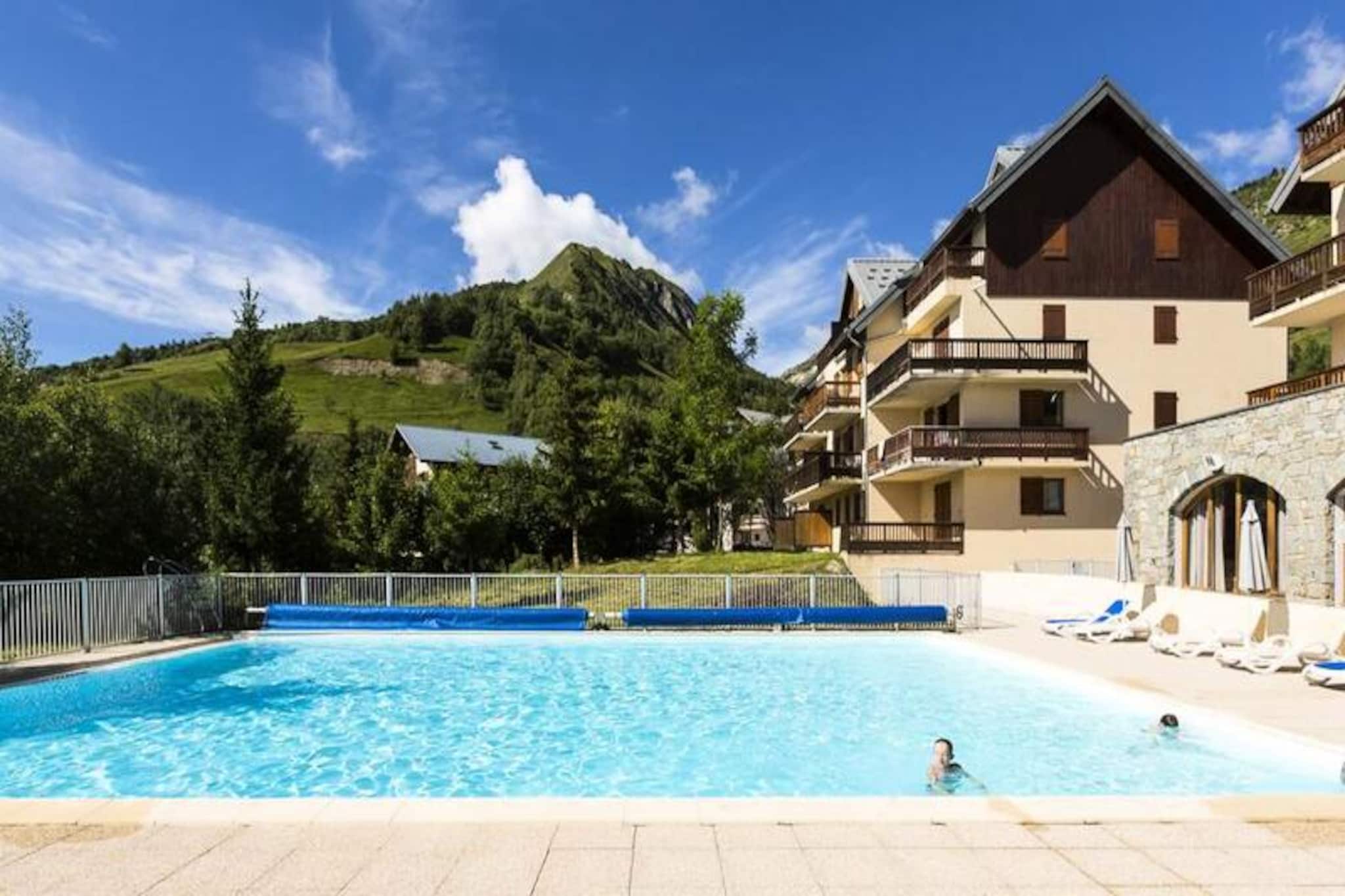 Spread over three levels without an elevator, this charming residence offers 73 well-appointed apartments, located just 1500 meters from the heart of Saint Sorlin d'Arves. The apartments are designed to accommodate up to 8 people, with living areas featuring a trundle bed, a double bedroom, a second bedroom with either a double bed or two single beds, and a closed mountain corner with two bunk beds. The residence is pet-friendly, allowing pets to stay with an additional fee.

Nestled in the heart of the stunning Savoyard region, the residence offers easy access to various outdoor activities. Just 600 meters from the shops, visitors can enjoy activities like climbing, mountain biking, and hiking around the beautiful lakes and glaciers. The region is also home to local attractions such as a cheese factory, and a variety of wellness options. For families, children's activities and guided hikes are offered, with hikes for people with reduced mobility.

The apartments are equipped with a fully functional kitchen, making self-catering convenient. The residence features a heated outdoor swimming pool and offers additional amenities such as free parking, baby kits, and comfortable seating areas. Wi-Fi is available for an extra charge, and a television is included in each apartment for entertainment.