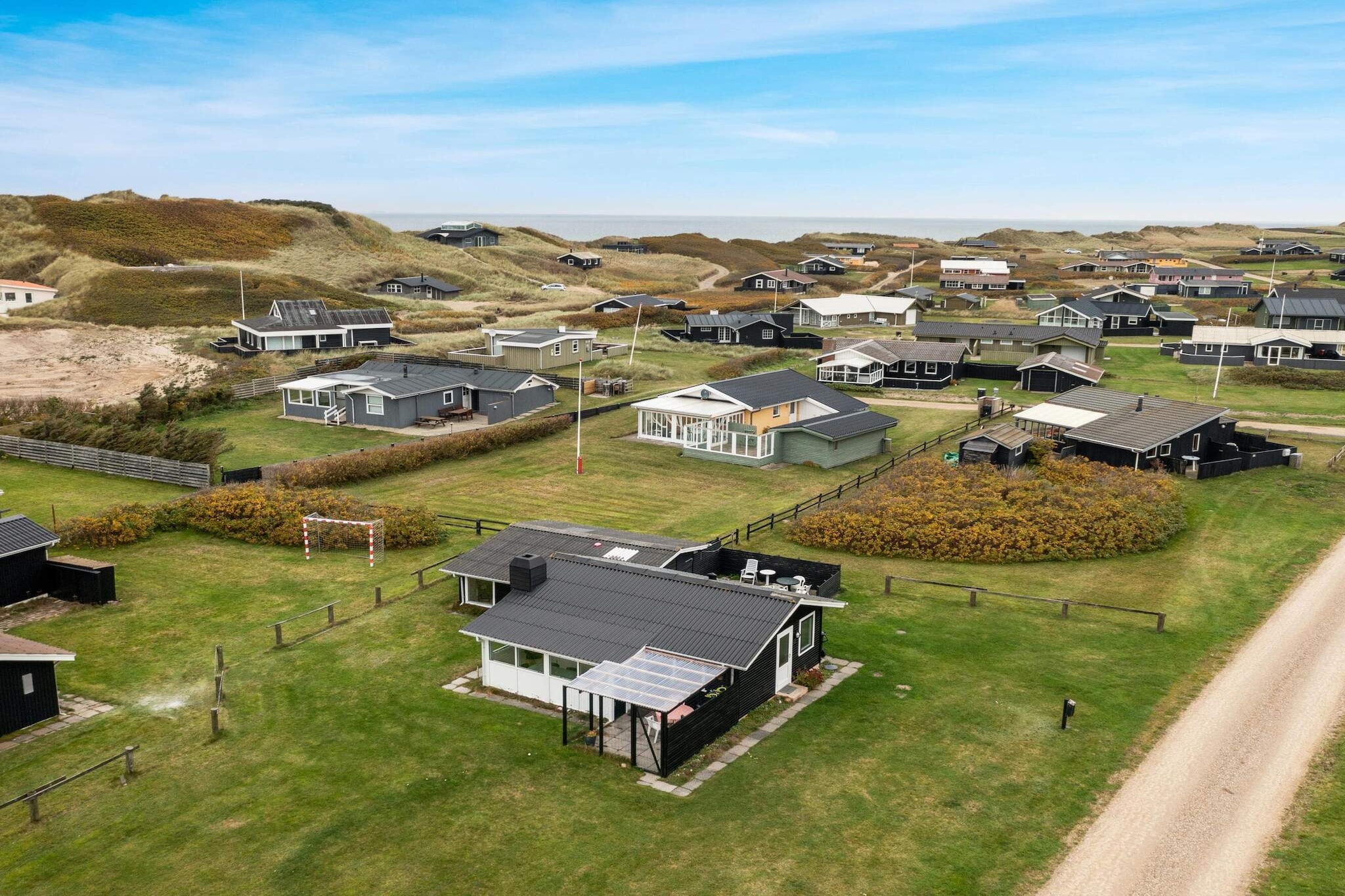 Sitting room(2x single bed), Kitchen(dishwasher, fridge, fridge-freezer), Living/bed room(TV(danish TV channels (DR1 and TV2)), chromecast), bedroom(2x single bed), bedroom(2x bunk bed), bathroom(washbasin, shower, toilet), carport, garden furniture