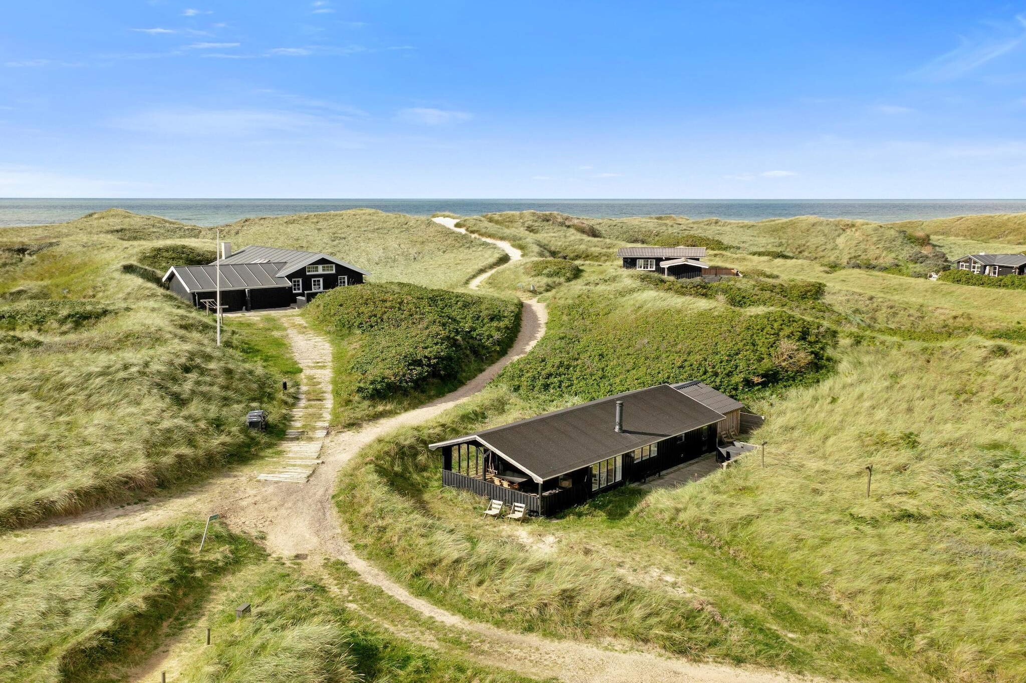 Kitchen(cooker(electric), cooker(2 ring stoves), coffee machine, oven, microwave, dishwasher, fridge, fridge-freezer), Living/bed room(single folding bed, TV(danish TV channels (DR1 and TV2)), chromecast), bedroom(double bed), bedroom(2x bunk bed), bathroom(washbasin, shower, toilet), sauna(shared with other guests, indoor), garden furniture