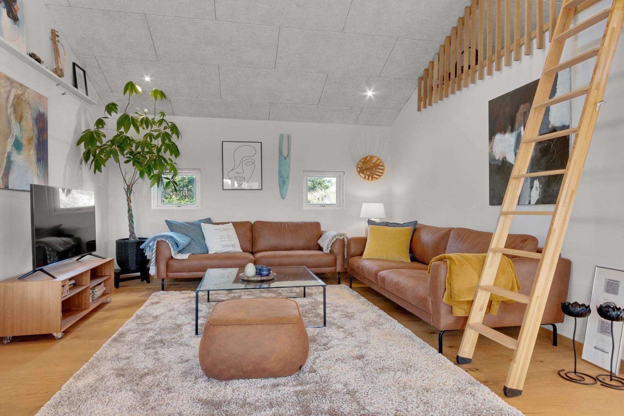 This charming summer house offers an inviting open-plan layout, perfect for cozy conversations and quality time with family or friends. The bright kitchen seamlessly connects to the living and family rooms, creating a spacious and airy atmosphere. Above the living space, a beautiful loft is separated by a decorative railing, enhancing the sense of luxury and light throughout the house. With two bedrooms and the loft, the house comfortably accommodates up to 6 people, making it ideal for families or small groups. The property is conveniently located just a short distance from Blokhus town, the stunning beach, and the popular FÃ¥rup Sommerland, offering easy access to a variety of activities. The land itself is a true highlight, with hilly terrain that adds charm and character to the setting. From the large terrace, you can enjoy beautiful views of the surrounding nature and nearby summer houses. The sunny terrace is the perfect spot to relax, unwind, and soak in the peaceful atmosphere. Sustainability is a key feature of this home, as it is equipped with solar panels, ensuring low electricity consumption. Whether you're spending time indoors or enjoying the outdoors, Krylevej 10 provides a perfect blend of comfort, convenience, and nature. Please note, the cottage is non-smoking and youth groups are not permitted. Don't forget to order linen packages when booking to avoid extra administration fees, ensuring a hassle-free stay.