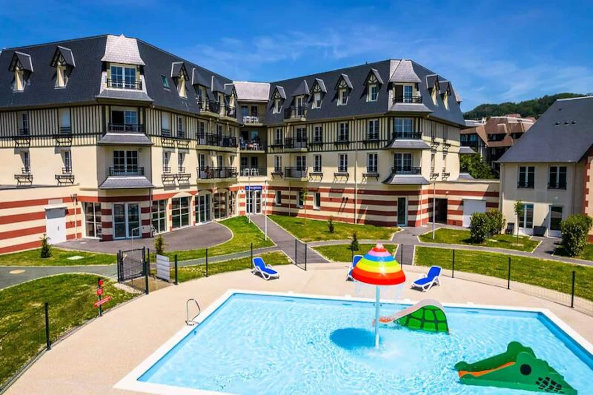 This charming holiday home provides comfortable accommodations with a range of sleeping options, including a double bed, a sofa bed, and additional rooms with twin beds. The property is pet-friendly, allowing one animal per unit for a small fee, making it ideal for families traveling with pets. Guests can enjoy a heated indoor pool and an outdoor children’s pool, while the wellness area offers a sauna and hammam for added relaxation. A fitness room and secure bicycle storage are also available for active visitors.

Located just 300 meters from a beautiful sandy beach and 4 km from Deauville, this property is perfectly positioned for both relaxation and exploration. Guests can stroll along the coastline, visit nearby markets for fresh local produce, and enjoy meals at charming cafes or gourmet restaurants. The area offers a family-friendly atmosphere with playgrounds, outdoor activities, and cultural attractions, ensuring something for everyone.

Each unit features a fully equipped kitchen with modern appliances, a comfortable living space, and a well-appointed bathroom. Free Wi-Fi is provided in the reception area, with extended access available for purchase. Additional amenities include laundry services, baby kits, and the option to order fresh bread and pastries. Parking is available on-site, and guests can rent bed linens and towels for a small fee. This property promises a delightful and convenient stay for all travelers.