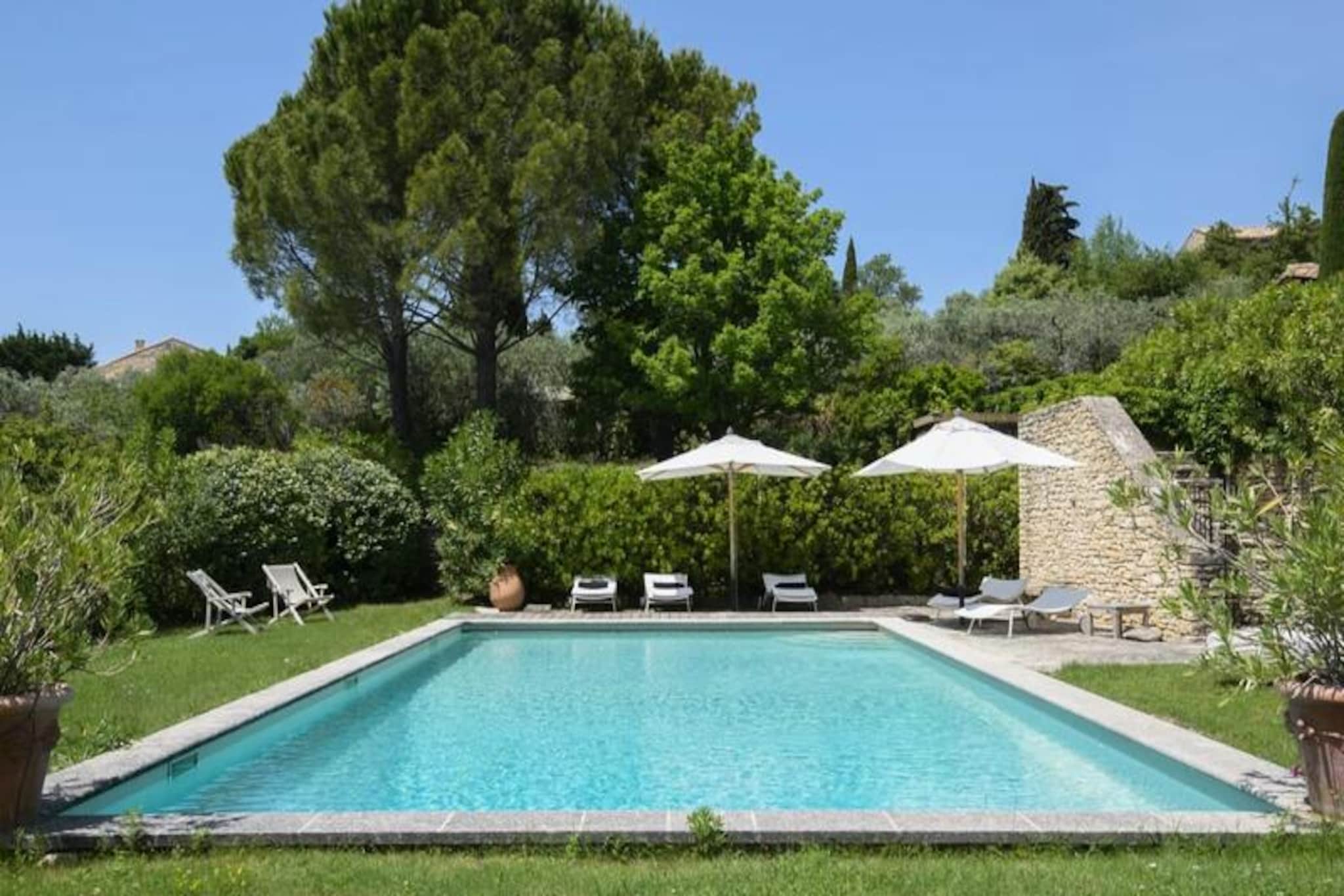 This beautifully renovated 300m² Provençal mas, nestled within a magnificent property near Gordes in the Luberon, accommodates up to 12 guests in six air-conditioned bedrooms. It offers a dominant position and creates an intimate atmosphere, perfect for a relaxing getaway.

Located steps from the center of Gordes, one of the most beautiful villages in the Luberon, this holiday home provides easy access to shops, cafes, bistros, and the local market. It’s an ideal base for exploring the Luberon Regional Natural Park, including the Bories village and Sénanque Abbey. Nearby perched villages like Roussillon, Lacoste, Bonnieux, and Ménerbes are also worth visiting.

The mas features a living room with a fireplace, a dining room, a fully equipped kitchen, six bedrooms, and multiple bathrooms. Outside, there are several terraces, a garden with olive trees and a fountain, a secure 12x7m heated swimming pool, a private garage, and parking. Linens, towels, and bathrobes are provided, beds are made upon arrival, and toiletries and refreshments are provided. Four hours of weekly cleaning are included. Optional services include a private chef, extra cleaning, wine tours, bike rentals, and grocery delivery. A manager is available to assist guests. A deposit is required.
