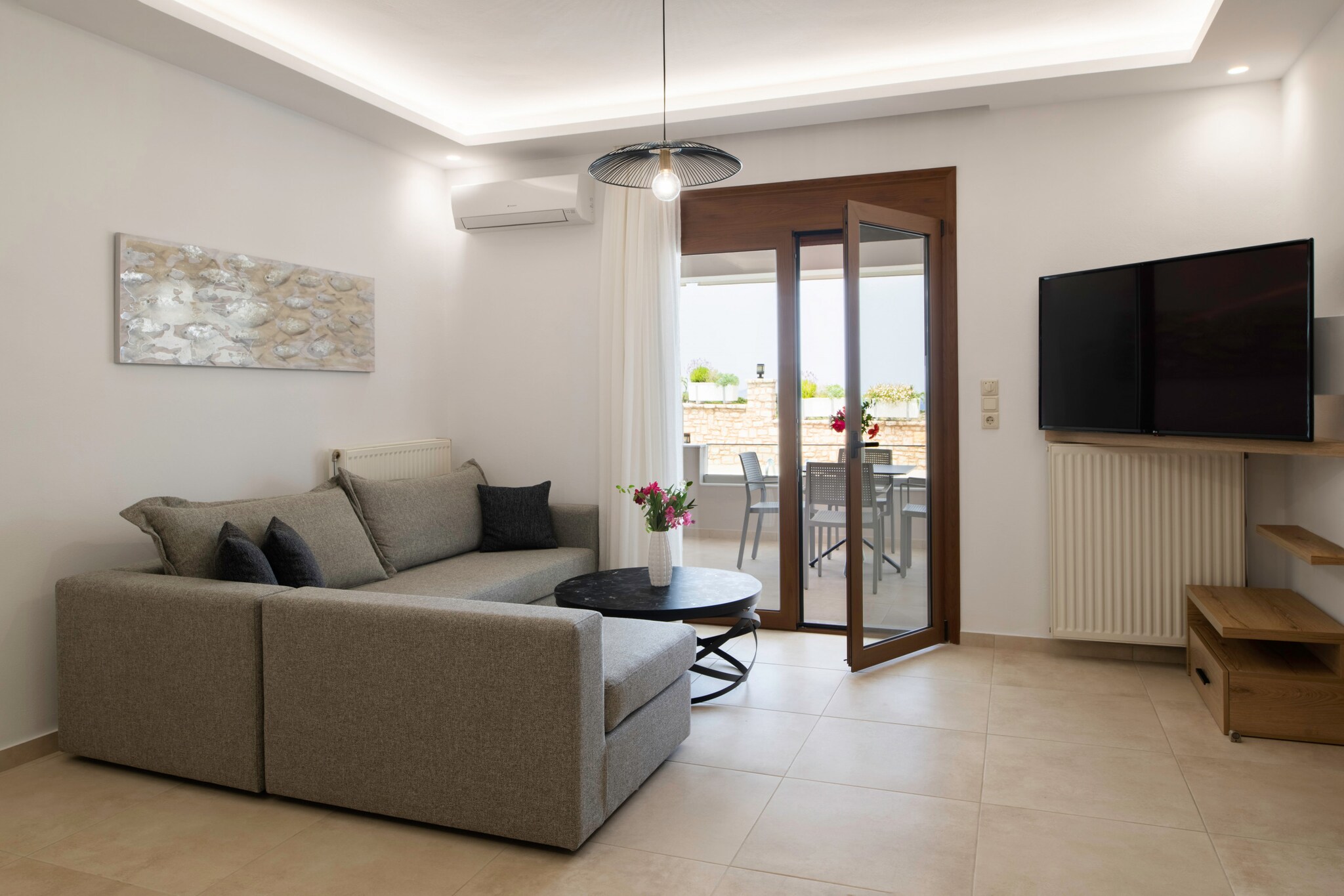 This charming 2-bedroom apartment in Nea Magnisia offers comfortable accommodation for up to 4 guests across 80 mÂ² of fully-equipped living space. Surrounded by stunning mountain views and a well-maintained garden, the apartment features a communal swimming pool, outdoor terrace with furniture, and a peaceful rural setting, perfect for relaxation. With central heating, air conditioning, and Wi-Fi, guests can enjoy modern comforts throughout their stay.

The property is ideally located just 1 km from the local beach, supermarket, and taverns, providing convenient access to the essentials. The city of Rethymno is only 10 km away, offering plenty of shops, restaurants, and cultural sites to explore. Heraklion Airport is 70 km from the apartment, ensuring easy access for travelers. Situated in a family-friendly zone, the area offers a tranquil environment while still being close to local attractions and amenities.

The apartment's open-plan kitchen is fully equipped with a refrigerator, microwave, oven, freezer, dishwasher, and a variety of kitchen utensils, including a coffee machine, toaster, kettle, and juicer. Additional amenities include a washing machine, dryer, barbecue, iron, hair dryer, and a safe for peace of mind. With a balcony, outdoor furniture, and open-air parking available, this apartment provides all the essentials for a convenient and enjoyable stay.