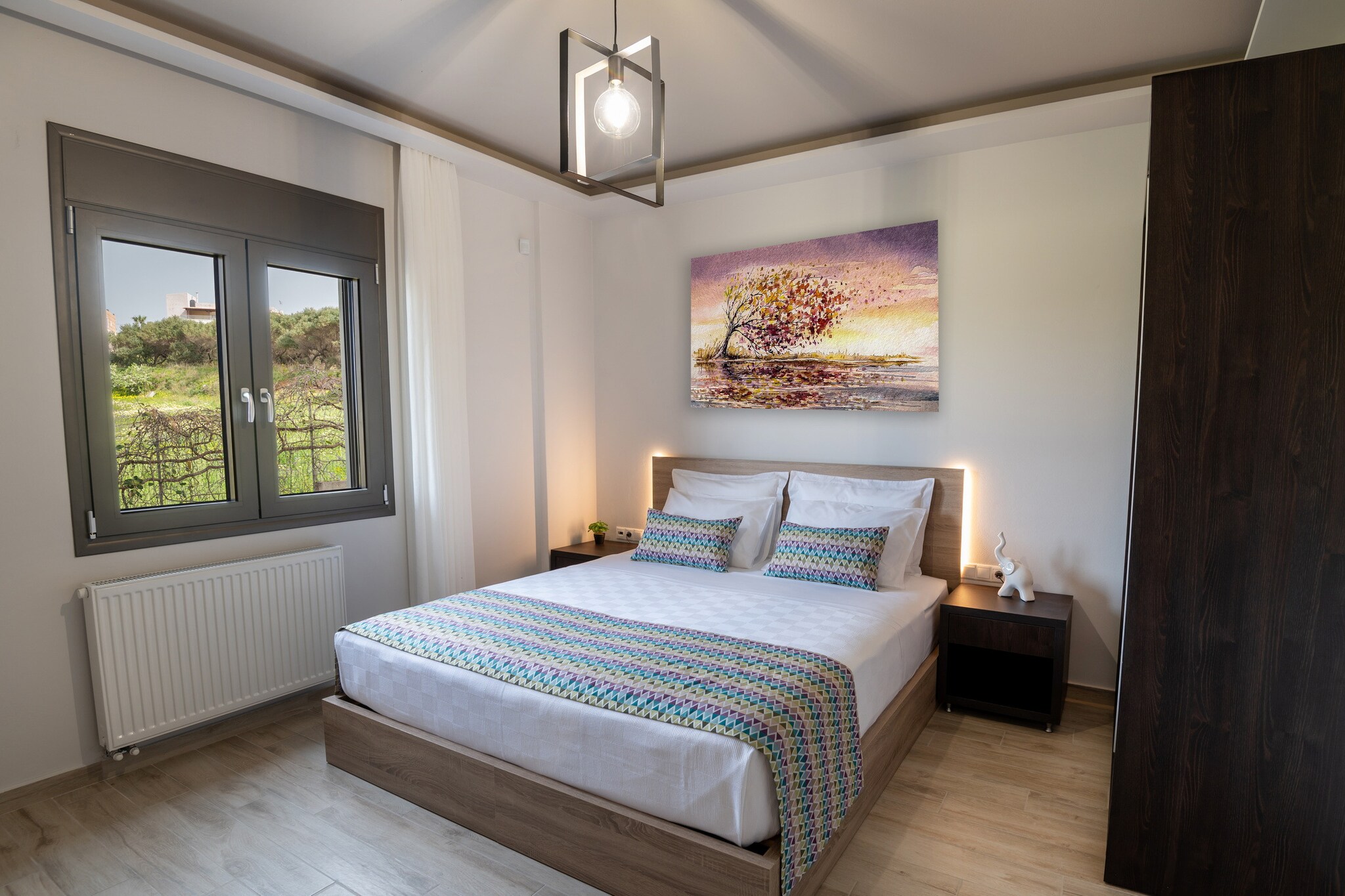 This tastefully furnished and modern 2-bedroom apartment in Agios Markos is ideal for up to 6 guests, with a maximum of 5 adults. With a spacious 75 mÂ² layout, the apartment offers beautiful views of both the waterfront and surrounding mountains, creating a serene and relaxing atmosphere. Located just 500 meters from the local supermarket and taverns, and only 2 km from the sandy beach of Rethymno, the property is in a family-friendly suburb, making it a perfect base for exploring the area. 

The accommodation is equipped with everything needed for a comfortable stay, including a garden with outdoor furniture, a terrace, and a fenced plot for privacy. For added convenience, thereâ€™s a communal swimming pool with a children's area, ideal for family vacations. The apartment features air conditioning, Wi-Fi, a TV with satellite channels, and a safe. Other amenities include a washing machine, iron, hair dryer, and a balcony to enjoy the views. Open-air parking is available in the same building, ensuring ease of access.

The open-plan kitchen is fully equipped with modern appliances, including a refrigerator, microwave, oven, freezer, dishwasher, coffee machine, toaster, kettle, juicer, and all the necessary kitchenware such as dishes, cutlery, plates, and bowls, making it easy to prepare meals. Whether youâ€™re enjoying the peaceful garden, relaxing by the pool, or exploring nearby beaches and attractions, this apartment in Agios Markos provides a comfortable and convenient stay for families or small groups.