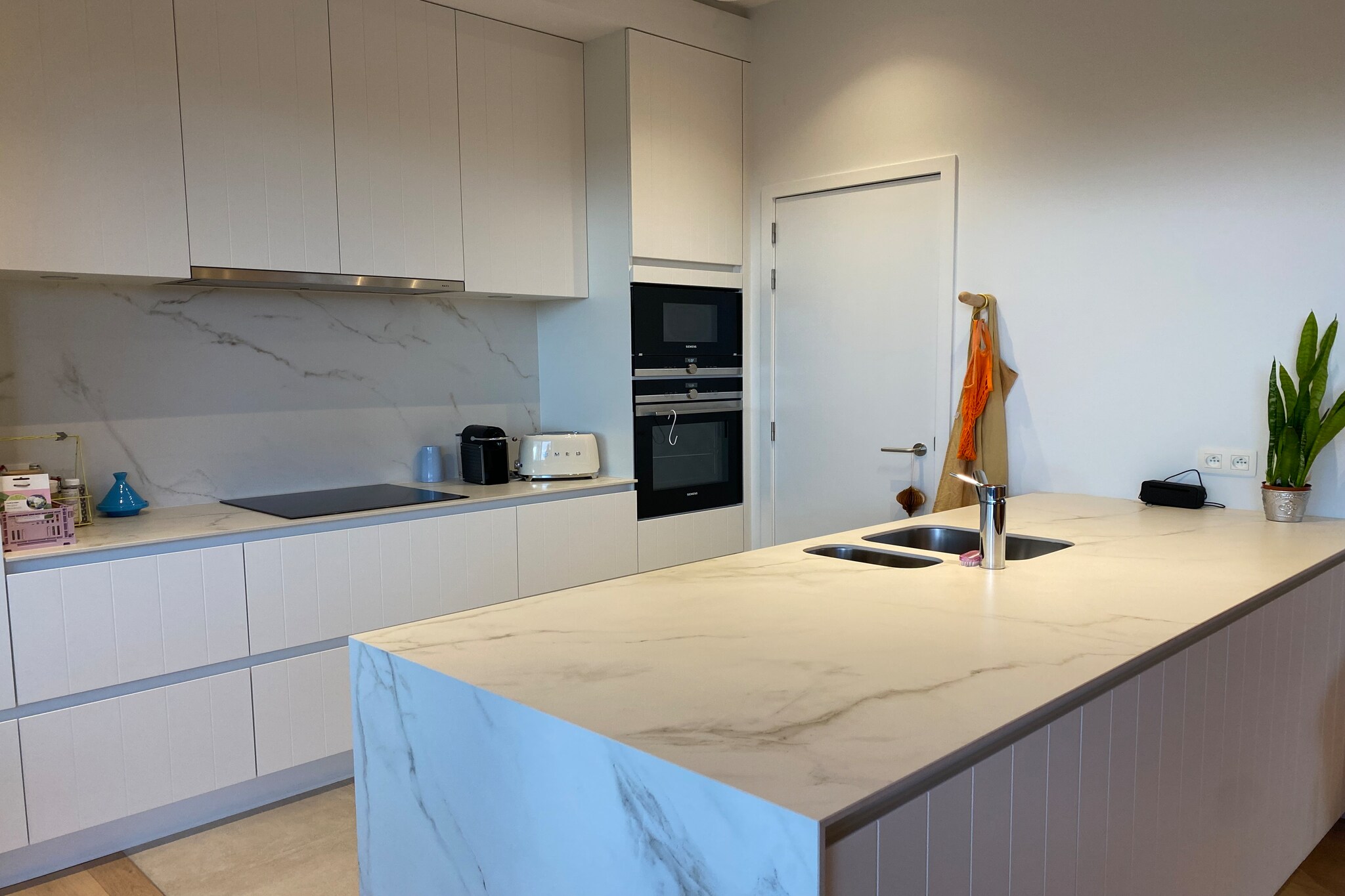 This modern apartment offers a comfortable stay for up to four guests, with two bedrooms and two bathrooms. The first bedroom features a double bed, while the second bedroom has two single beds, making it ideal for families or small groups. The apartment is non-pet-friendly and is equipped with Wi-Fi, a digital TV, and a large sun terrace with outdoor furniture. Additionally, guests enjoy the convenience of an underground parking space and two bicycle spaces in the building. The property is also wheelchair accessible, ensuring easy access for all visitors.

Located between the dunes, the apartment provides a tranquil setting while being close to key attractions. Just a short drive away, guests can explore the nearby golf course, Ter Hille Koksijde, and the bustling Marina Nieuwpoort. The popular Plopsaland De Panne theme park is also within reach, offering fun for families. Local cafes, markets, and restaurants are easily accessible, allowing guests to experience the local culture and cuisine.

Inside, the apartment features an open kitchen with an electric stove, fridge with freezer compartment, dishwasher, and all necessary cookware. The two bathrooms are conveniently located, one attached to the main bedroom, and the other separate for guestsâ€™ use. For added convenience, a washing machine and dryer are available for a fee. A household waste room and general laundry facilities are also provided within the building. The sunny side of the apartment ensures a bright and pleasant atmosphere throughout your stay.