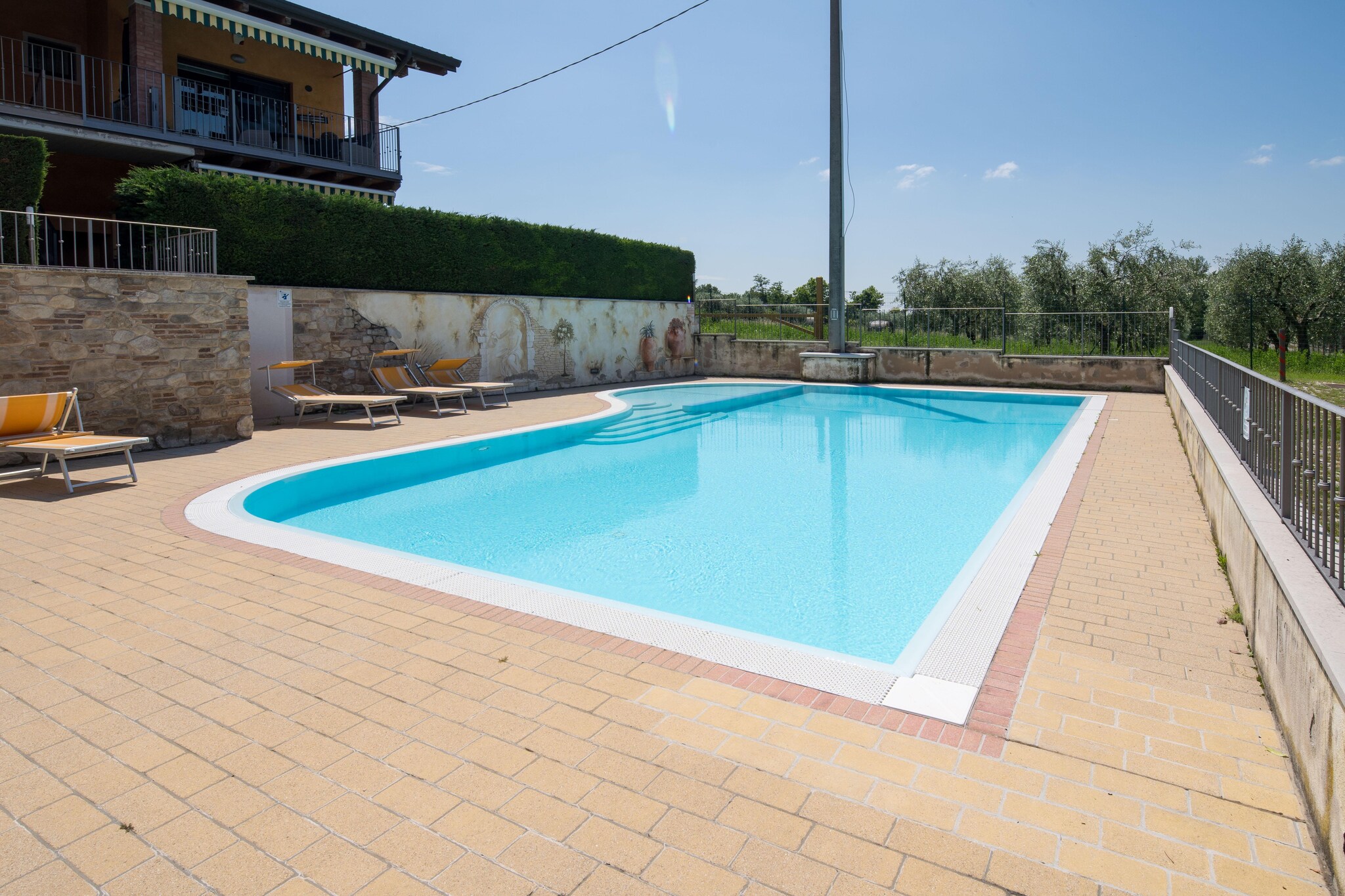 Lakeside Leisure & Local Attractions Lazise, meaning â€œplace on the lake,â€ offers medieval charm and scenic beauty. Just steps from Lake Gardaâ€™s harbor, guests can enjoy boating or explore theme parks like Gardaland and Caneva Aquapark. Restaurants and shops are within walking distance, and the town center is perfect for evening strolls.

Apartment Features & Comforts Costa al Sole is a well-appointed first-floor flat in Pacengo di Lazise. It includes a cozy living room, modern kitchenette, double bedroom, and a bathroom with shower. Upstairs, a second bedroom opens to a private terrace with lake views and a bathroom with bathtub. Amenities include air conditioning, satellite TV, and free Wi-Fi.

Residence & Outdoor Perks Set in a small residence with a shared pool, this holiday home is 15 minutes from the lake and close to essential services. Guests enjoy a balcony with lake views, a garage with secure parking, and access to a peaceful garden. The location between Pacengo and Lazise makes it ideal for both relaxation and adventure.