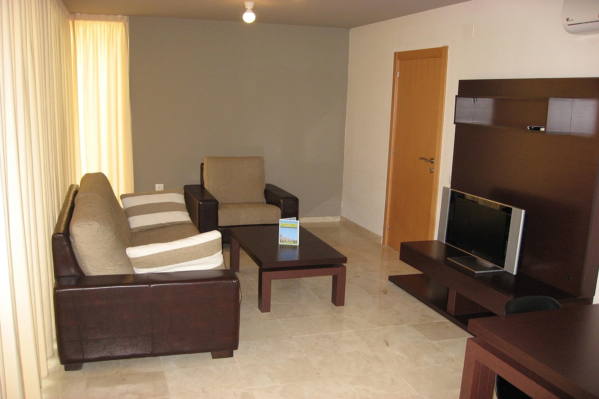 These semi-detached houses, each with two modern apartments, stand out on the outskirts of La Escala due to their sleek architecture and design. Set in a beautifully landscaped garden with palm trees, oleanders, and other lush plants, the property invites you to relax in the sun beside the pool. Inside, the apartments feature a modern, well-coordinated color scheme with clean lines and spacious layouts, creating a calming atmosphere. Located just 1.5 km from the beach and the charming "Els Riells" promenade, this property offers an ideal setting for a tranquil yet active getaway.
La Escala is a small coastal town in the southern Bay of Roses, 120 km from Barcelona, offering a variety of leisure and sports activities. Enjoy bicycle rentals, mini golf, tennis, and diving, or explore the picturesque old town for a taste of local culture. The area also boasts several beautiful beaches for sunbathing and water sports, providing endless options for fun and relaxation. With a wealth of nearby attractions, you can easily immerse yourself in the vibrant local life.
Other amenities at the complex include three outdoor swimming pools, with four additional pools of 18 sqm each open from April to October. There is a common terrace with garden furniture and parasols, perfect for unwinding. The reception area offers Wi-Fi, and for an additional fee, you can enjoy massages or rent bicycles to explore the surroundings. Please note, the property is not suitable for people with reduced mobility.