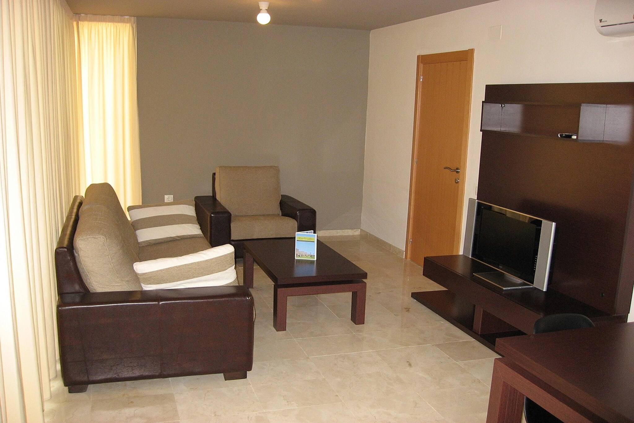 These semi-detached houses, each with two modern apartments, are a standout in La Escala, thanks to their striking architecture and thoughtfully designed interiors. The beautifully landscaped garden area, complete with palm trees, oleanders, and vibrant plants, creates a serene space to relax by the pool under the sun. The apartments feature a contemporary, spacious design, with well-coordinated colors, clear lines, and an open layout that offers both comfort and style. Located just 1.5 km from the beach and the scenic "Els Riells" promenade, this property is a perfect blend of tranquility and convenience.
La Escala, a charming town located in the southern Bay of Roses, offers a wealth of leisure and sports activities. Explore the area with options such as bicycle rentals, mini golf, tennis, and diving. The picturesque old town adds cultural charm, and the nearby beaches provide ample opportunities for relaxation or water sports. The region's natural beauty and vibrant atmosphere ensure there's something for everyone to enjoy, from outdoor adventures to soaking in the local culture.
The complex features three outdoor pools and four smaller 18 sqm pools (open from April to October), as well as sun loungers for ultimate relaxation. Guests can also enjoy the communal terrace with garden furniture and parasols. Wi-Fi is available in the reception area, and for an additional fee, you can book massages or rent bicycles. Please note that the property is not suitable for people with reduced mobility.