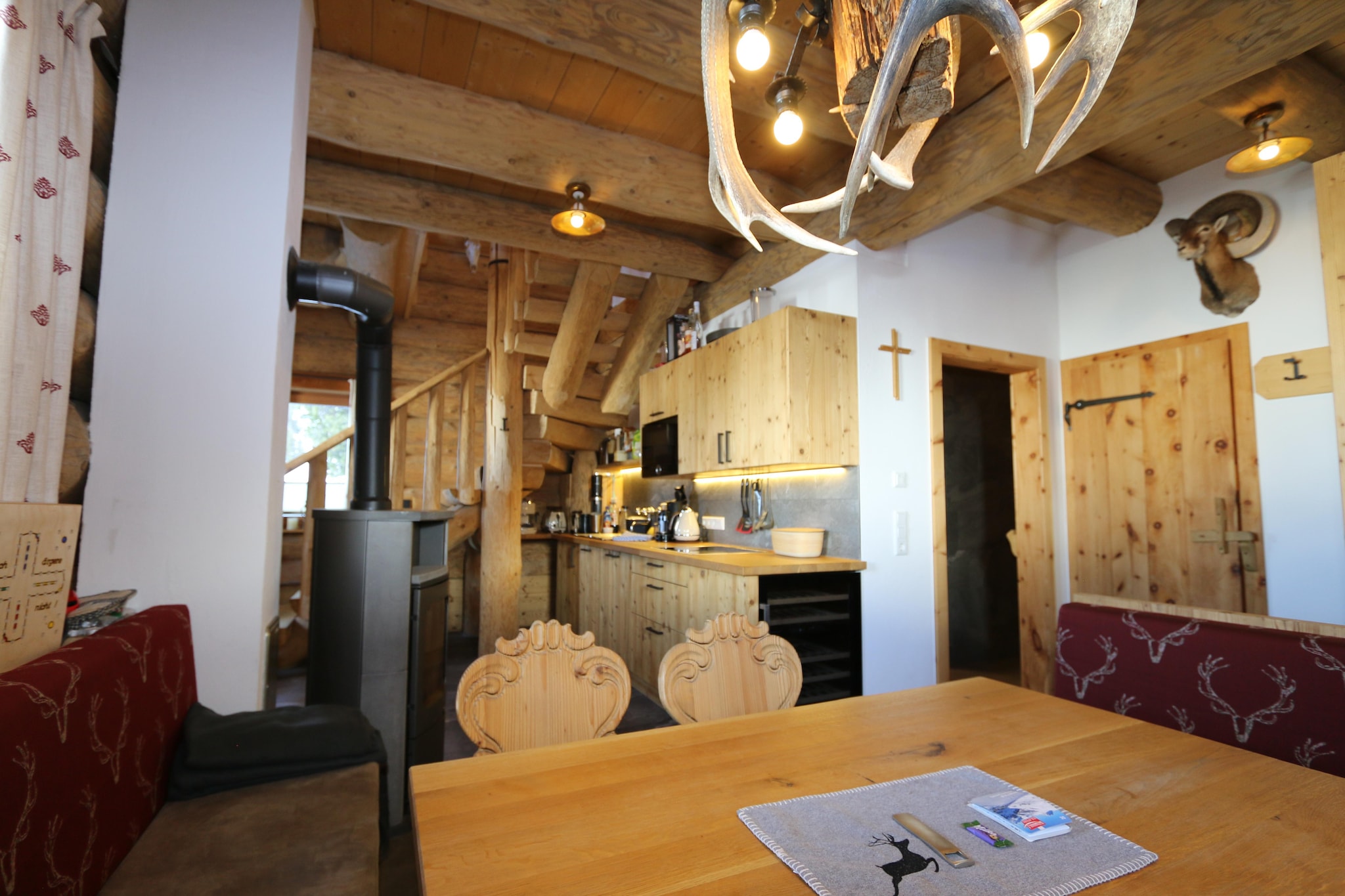 Ground floor: (Kitchenette(electric kettle, toaster, cooker(4 ring stoves, ceramic, induction), coffee machine(cups, filter), oven, microwave, dishwasher, fridge, freezer, Wine glasses), Living/diningroom(dining table), bathroom(shower, sauna, washbasin), toilet, storage(washing machine, ski boot heaters), fireplace, hot tub, terrace, pond)\n\nOn the 1st floor: (Living room(double sofa bed, TV(cable)), bedroom(double bed, TV(cable)), bedroom(double bed, TV(cable)), bedroom(single bed, single bed, TV(cable)), bathroom(shower, toilet))