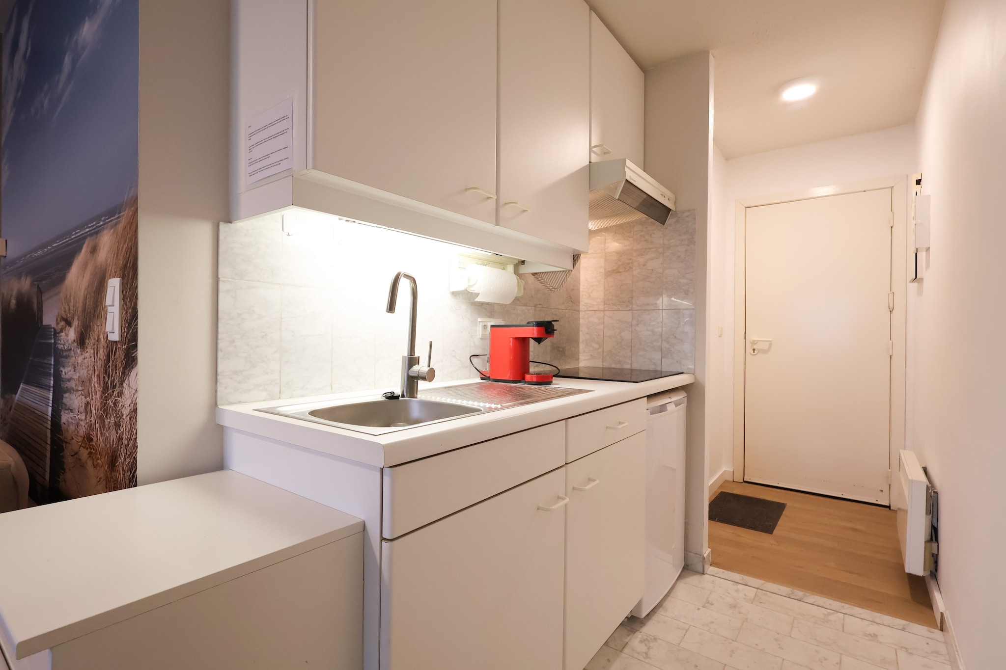 This cozy apartment on the third floor offers a comfortable stay for up to four guests. The living and dining area features a welcoming seating space, a dining table, and a flat-screen digital TV for entertainment. A double sofa bed provides additional sleeping arrangements, while a separate sleeping niche includes a bunk bed for a restful nightâ€™s sleep. The apartment is entirely smoke-free and does not allow pets, ensuring a clean and pleasant environment. A private patio offers a relaxing outdoor space, perfect for unwinding after a long day.  

Situated in a prime location, the apartment provides easy access to local attractions, making it an excellent choice for those looking to explore the area. A short walk takes you to charming cafÃ©s, bustling markets, and inviting restaurants, where you can savor fresh seafood and regional delicacies. The nearby beach and promenade are ideal for leisurely strolls, while cycling paths and scenic viewpoints offer breathtaking coastal views. Whether you prefer shopping, dining, or outdoor adventures, this location has something for everyone.  

The apartment is equipped with a convenient kitchenette, featuring a coffee machine, oven, microwave, and fridge-freezer for preparing meals with ease. The modern bathroom includes a bathtub, shower, and sink, providing all necessary comforts. A lift ensures easy access to the third floor, making this apartment an excellent choice for a relaxing and enjoyable stay.