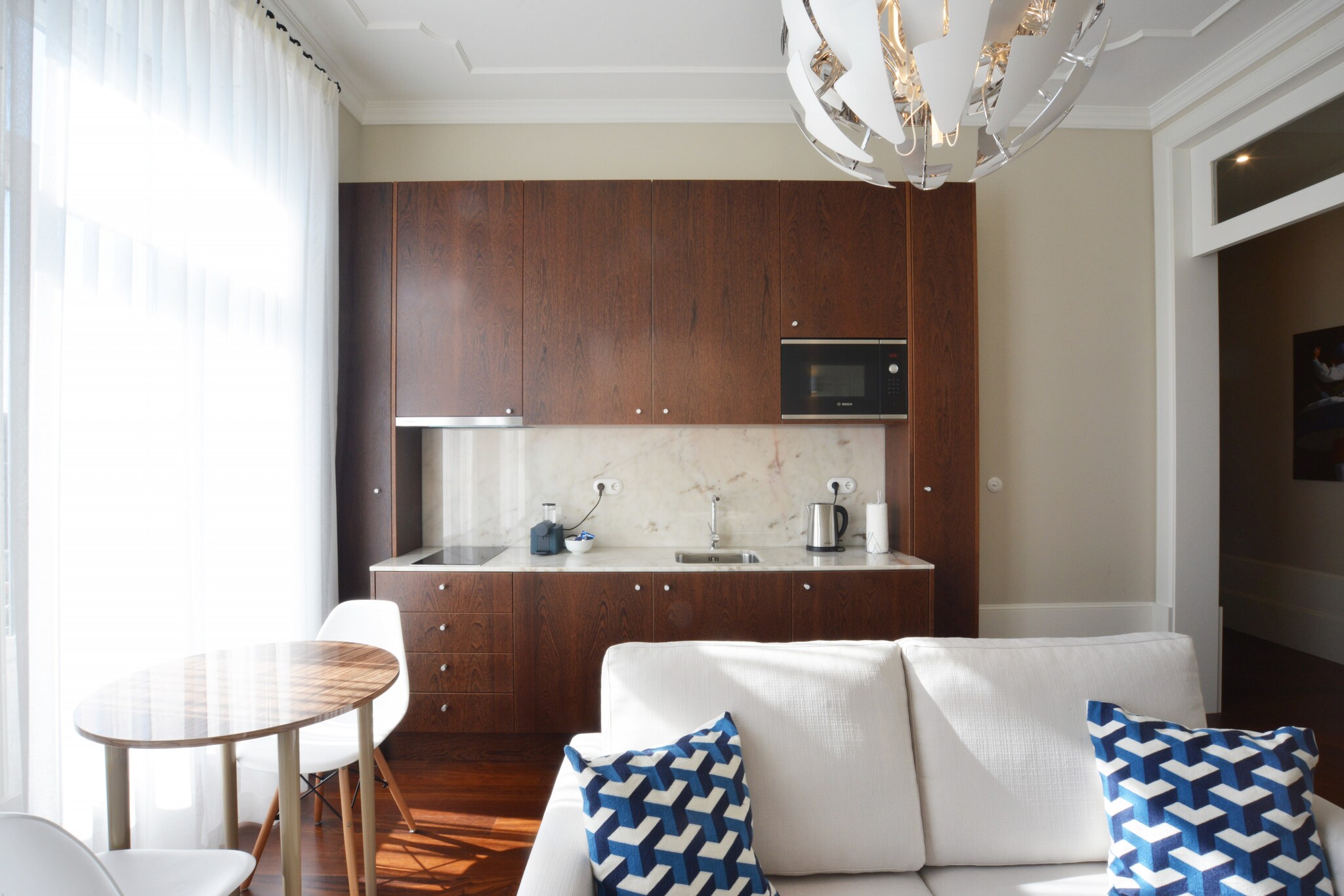 This apartment, along with its modern and inviting design, provides a comfortable stay for up to 4 guests. It includes two spacious bedrooms, one with a double bed and the other with a single bed, ensuring privacy and comfort. The living room is well-equipped with a cozy sofa, perfect for relaxing after a day of sightseeing. The apartment also features a private balcony where guests can enjoy the view. Free Wi-Fi is available throughout the apartment, and additional amenities such as a high chair and a crib are available upon request. Please note, the property is not pet-friendly.

The apartment is conveniently located in the heart of the city, just a short walk from various attractions, cafes, and restaurants. The metro station is within a 5-minute walk, making it easy to explore nearby landmarks. The famous historic district is only a few minutes away, and you can also find local shops, bars, and markets nearby. For those looking to experience the local culture and cuisine, the apartment's central location offers a wide range of options within walking distance.

Inside, the apartment features a fully equipped kitchen, including a refrigerator, oven, microwave, and coffee maker, ideal for preparing meals during your stay. The bathroom is complete with a shower and essential toiletries, including a hairdryer. The apartment also provides a washing machine and dryer for added convenience, making it perfect for longer stays. With all the necessary amenities, this apartment ensures a comfortable and convenient stay for its guests.