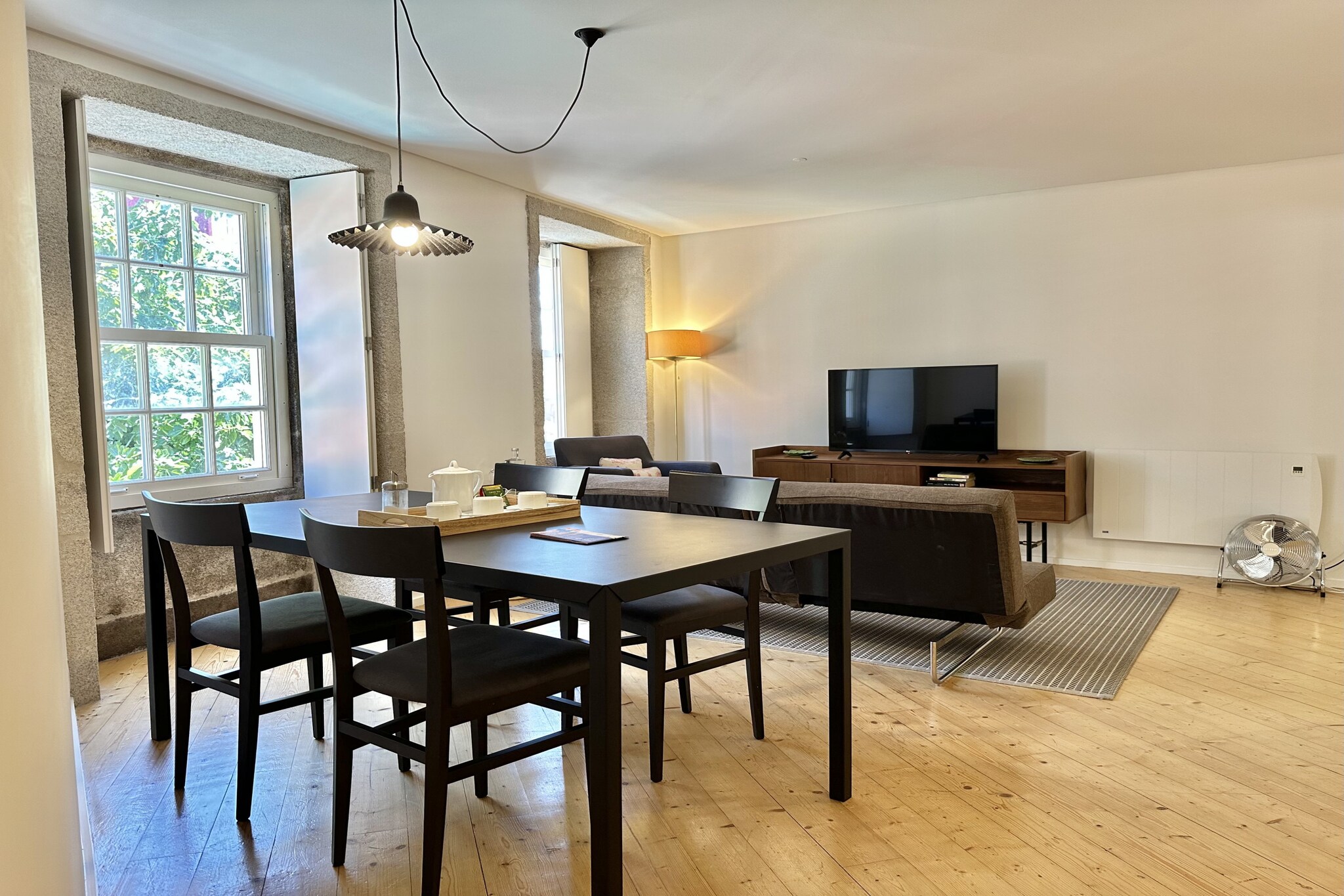 Tucked into the vibrant heart of Porto, this charming 1-bedroom apartment offers a warm and welcoming base for couples or small families. Just a short stroll from the city’s iconic attractions, it combines comfort, convenience, and cultural immersion in one delightful package.
The 45 m² space features a cozy bedroom with a double bed and a sofa bed, comfortably accommodating up to 3 guests. The full bathroom includes a shower, and the apartment is equipped with air conditioning, electric heating, and Wi-Fi to ensure a pleasant stay year-round.
The independent kitchen is fully stocked with everything you need to prepare home-cooked meals, including a refrigerator, freezer, oven, microwave, coffee machine, and essential utensils. After a day of exploring, unwind in the living area with cable TV offering channels in Spanish, English, French, and Portuguese. With its central location, you’ll be just minutes from Porto’s historic streets, lively cafés, and cultural landmarks. Whether you're here for a romantic getaway or a family adventure, this apartment offers the perfect blend of comfort and city charm.