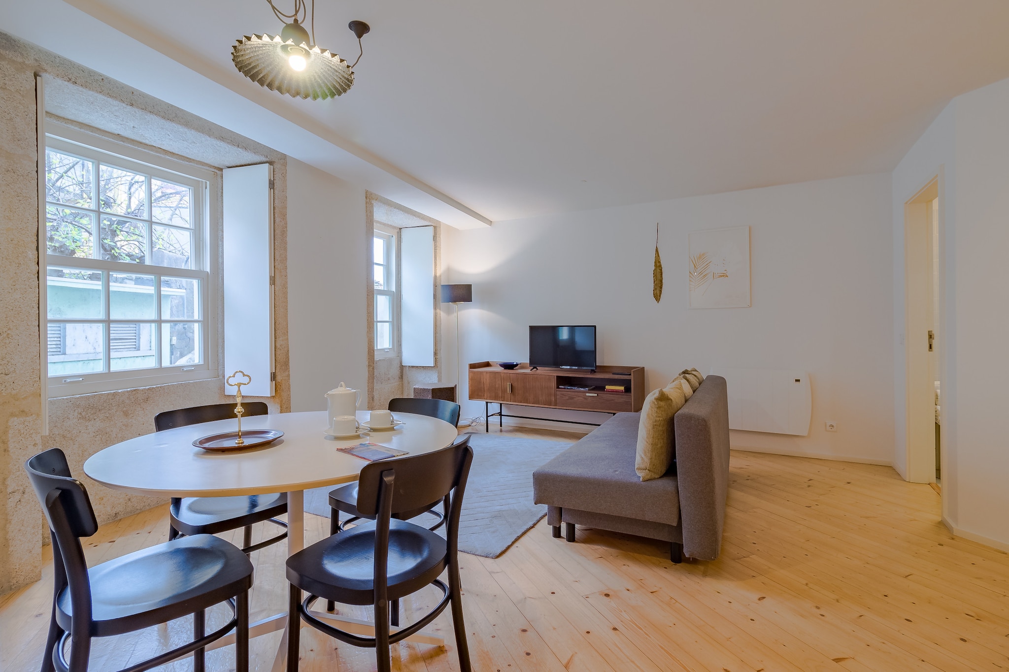 This cozy and modern apartment offers a comfortable stay for up to 3 guests with one bedroom and a bathroom. It is equipped with essential amenities like air conditioning, internet access, a baby high chair, and a cot/crib, making it an ideal choice for families. The apartment is not pet-friendly, and pets are not allowed. Additional amenities include bed linens and bath towels, all included for your convenience. The living space is well-furnished and includes a comfortable sofa in the living room, ensuring you can relax after a day of exploring.
Located in the heart of Porto, this apartment provides easy access to nearby attractions. It’s only 5 minutes from the metro station "Bolhão," and close to local supermarkets like "Pingo Doce." The famous Ribeira district is just 1 km away, offering visitors charming streets, riverside cafes, and scenic views. Public transport options such as the bus station "Campo 24 de Agosto" and the train station "S. Bento" are also within walking distance, providing easy connections throughout the city and beyond.
The apartment features a fully equipped kitchen with all necessary appliances, including a fridge, microwave, oven, and dishwasher, allowing guests to prepare meals during their stay. The modern bathroom includes essential amenities, making your stay as comfortable as possible. This apartment is perfect for travelers looking for a combination of comfort and convenience in a central Porto location.