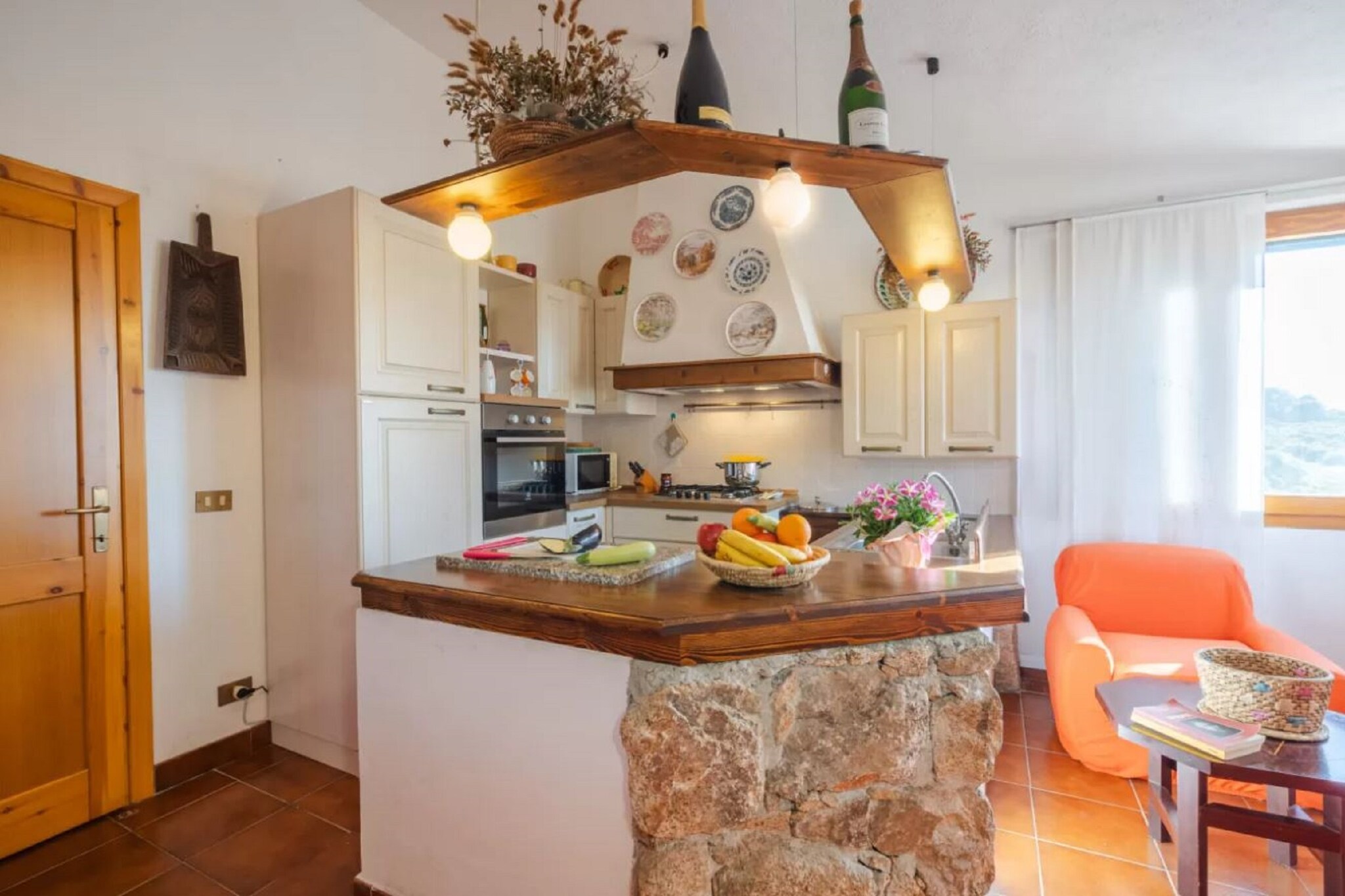 Nestled in the picturesque setting of Isola Rossa, this delightful holiday home serves as a perfect retreat for families or groups seeking relaxation and comfort. The ground floor features a welcoming living room complete with a cozy fireplace, a spacious seating area, and a dining table that invites shared meals and gatherings. The open kitchen is fully equipped with modern amenities, such as a hob, hood, oven, microwave, dishwasher, and fridge, making meal preparation a breeze. Accommodation includes three inviting bedrooms: one with a double bed, another also featuring a double bed, and a third with two single beds, providing versatile options for guests. 

The stylish bathroom is equipped with a shower, washbasin, toilet, and bidet, ensuring convenience for all guests. Additional amenities like air conditioning keep the interior cool during warmer days, while insect screens enhance the overall comfort. Outdoors, the property boasts a lovely patio and a well-maintained garden, featuring garden furniture for lounging and a BBQ, perfect for enjoying cookouts under the sun while surrounded by nature.

Nearby attractions make this holiday home an even more appealing choice. Guests can explore stunning beaches such as Cala Canneddi and Li Cossi, renowned for their crystal-clear waters and breathtaking scenery. The charming town center offers a variety of shops, restaurants, and cafÃ©s, ideal for sampling local cuisine and culture. Additionally, nature enthusiasts can hike along scenic coastal trails or visit Capo Testa for remarkable views and unique natural formations, making this location a great base for adventure and relaxation alike.