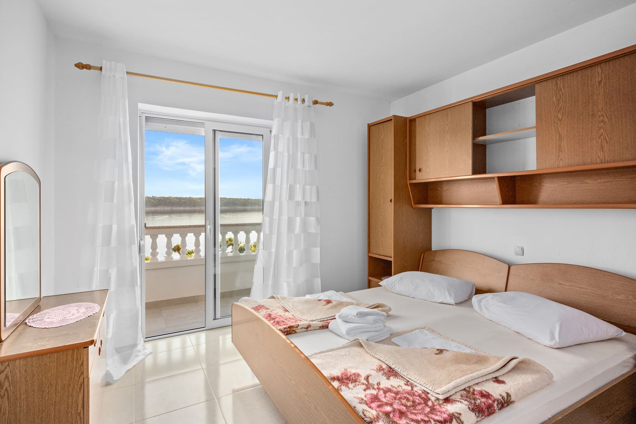 Escape to the serene island of Rab with a stay at Apartments Jurica, located in the charming village of Barbat. The one-bedroom apartment Petra, situated on the first floor, offers stunning sea views and the perfect setting for a peaceful getaway. The apartment features a cozy bedroom with a queen-size bed, a well-equipped kitchen with a dining area, and a bathroom with a shower. Enjoy your morning coffee or evening drinks on the spacious private balcony overlooking the sparkling Adriatic Sea.

This apartment is ideal for 2 adults and one child (up to 12 years of age), and is equipped with everything you need for a comfortable stay. For those staying longer, laundry services are available upon request. Guests have access to a shared outdoor patio with a dining area and summer kitchen, complete with a gas grill and dishwasherâ€”perfect for outdoor cooking and dining.

The property also offers a private dock with mooring, available for free use. If you're keen on exploring nearby islands, the hosts own a small boat that you can borrow (with prior notice and a valid boat license).

Rab is known for its sandy beaches, rich history, and charming old town, making it an excellent destination for families and history enthusiasts. Visit the ancient ruins of the Greek military fortress on St. Damian Hill, explore the picturesque streets of the Old Town, and enjoy local seafood at nearby restaurants. 

With private parking and easy access to beaches and attractions, Apartments Jurica is the perfect spot to relax and explore the beauty of Rab.