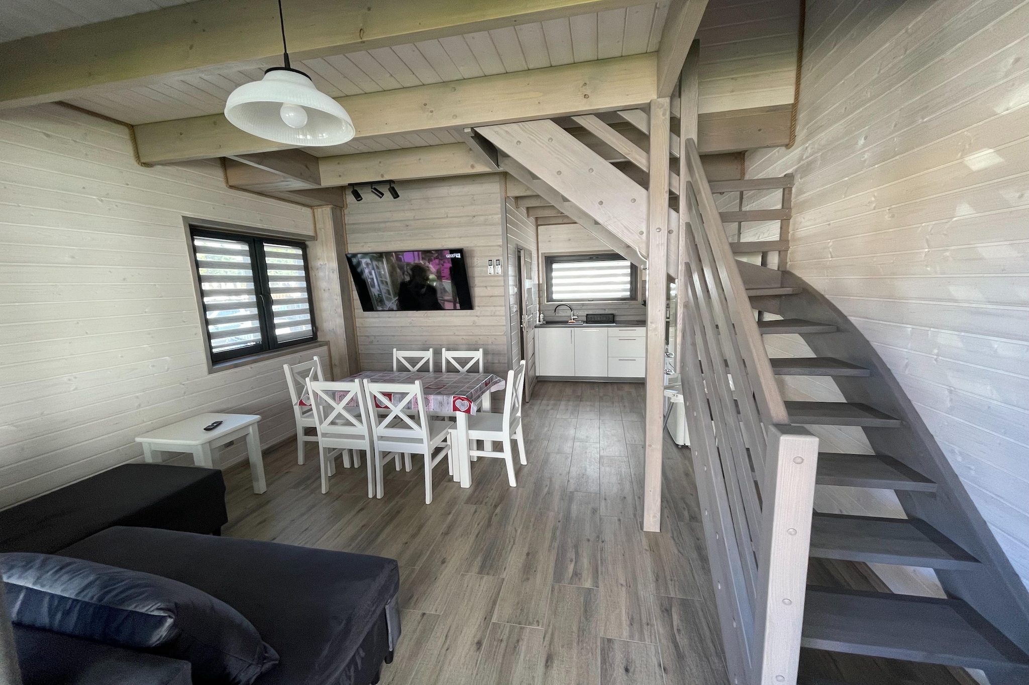 A family-friendly holiday resort in a very quiet area, 200 meters from the beach. Just a few steps from the resort center.

Comfortable, two-story holiday homes with covered terraces. On the ground floor, there's a spacious living room (TV, dining table, double sofa bed), a well-equipped kitchen (including a washing machine, dishwasher, and coffee maker), and a bathroom with a shower. On the first floor, there are two large, separate bedrooms and an additional toilet. The terrace is equipped with garden furniture and barbecue facilities. Air conditioning with cooling and heating functions is provided. Wireless internet is available.

The well-maintained and fenced grounds of the holiday resort include an attractive playground, a well-equipped playroom, bicycle rentals, table tennis, and foosball. A sauna and a whirlpool are available for an additional fee. Secure parking is available (one space per cottage is included in the price; an additional parking space is available at an additional cost).

The price includes: bed linen, internet, and parking (one space per cottage). A baby cot and highchair are available upon request (reservation required). Sianożęty is a small holiday village located approximately 10 km from Kołobrzeg, in the immediate vicinity of another seaside resort, Ustronie Morskie. Sianożęty is situated right next to a wide beach. The golden sand and gentle slope into the sea encourage vacationers to sunbathe and swim. Neighboring Ustronie Morskie also boasts a 100-meter-long pier. The international R-10 cycling trail runs through Sianożęty. It runs along the coast and offers stunning views of the beaches, clear sea, and charming peat bogs. From here, cycling is an easy and pleasant way to reach nearby Ustronie Morskie, as well as the larger city of Kołobrzeg.