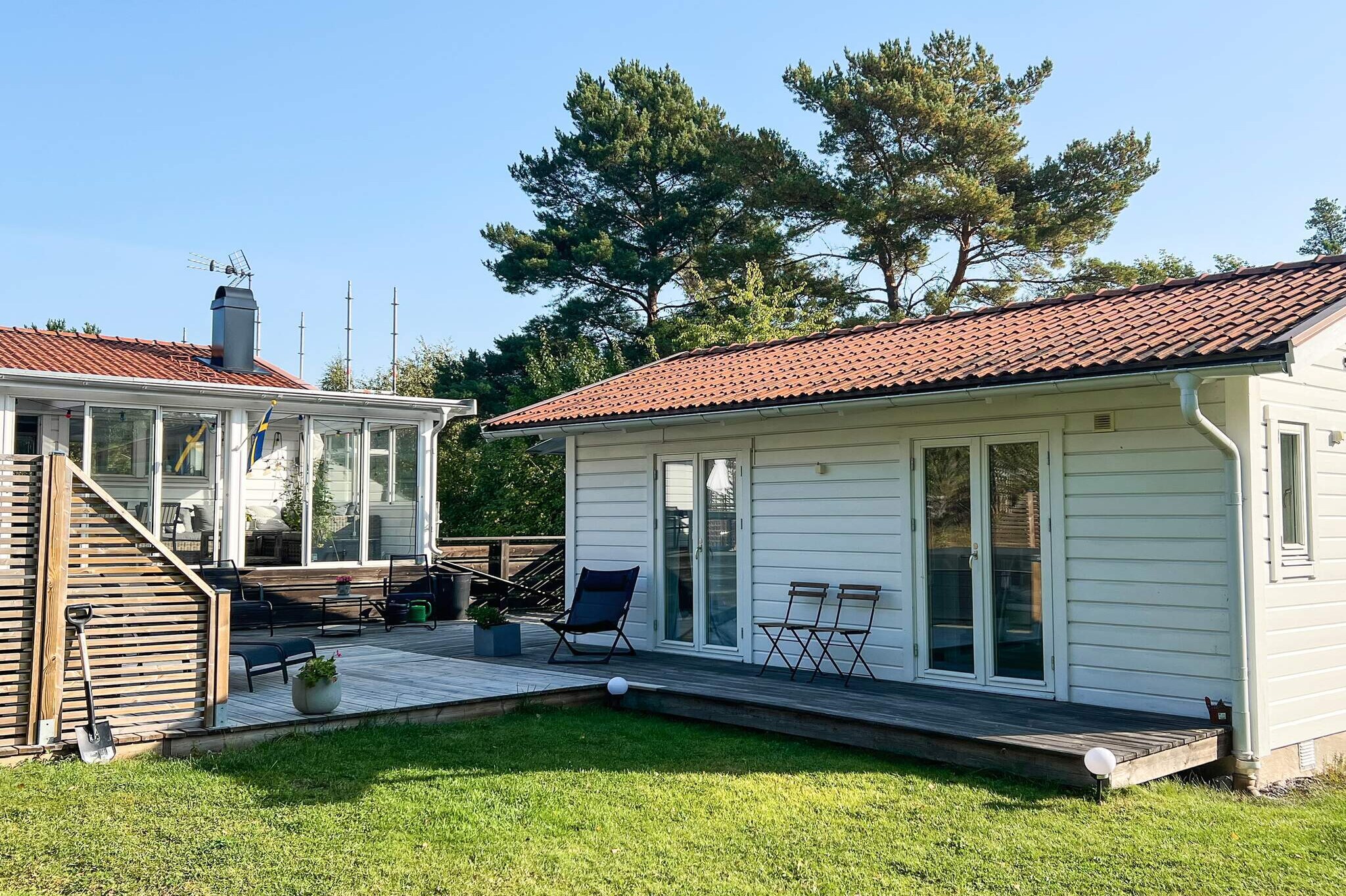 Welcome to this cozy house on VÃ¤rmdÃ¶ in the Stockholm archipelago. Close (350 m) to a lovely bathing rock for both morning and evening swims, a sandy beach with a playground is about 700 meters from the house. There are two well-furnished houses, both have bathrooms with shower and toilet, the larger house also has a combined washing machine and dryer. The large house has a well-equipped kitchen and the smaller one has a small fridge, a cooking plate and water boiler, so two families can live in their own house but still be together. Large balconies surround the houses, with plenty of space for a wonderful summer life. On the balcony there is a hot tub and sun loungers. A large lawn is available for games and play, the entire plot is also fenced, good for small children. There is a barbecue on the balcony, but if you want to eat out, it is not far to lovely restaurants by the water. There is a direct bus into Stockholm, the stop is only 100 meters from the house. There is a lot to discover on VÃ¤rmdÃ¶, plenty of flea markets, cafes, restaurants and archipelago boats, to discover the islands of the Stockholm archipelago. Not for rent to youth groups.