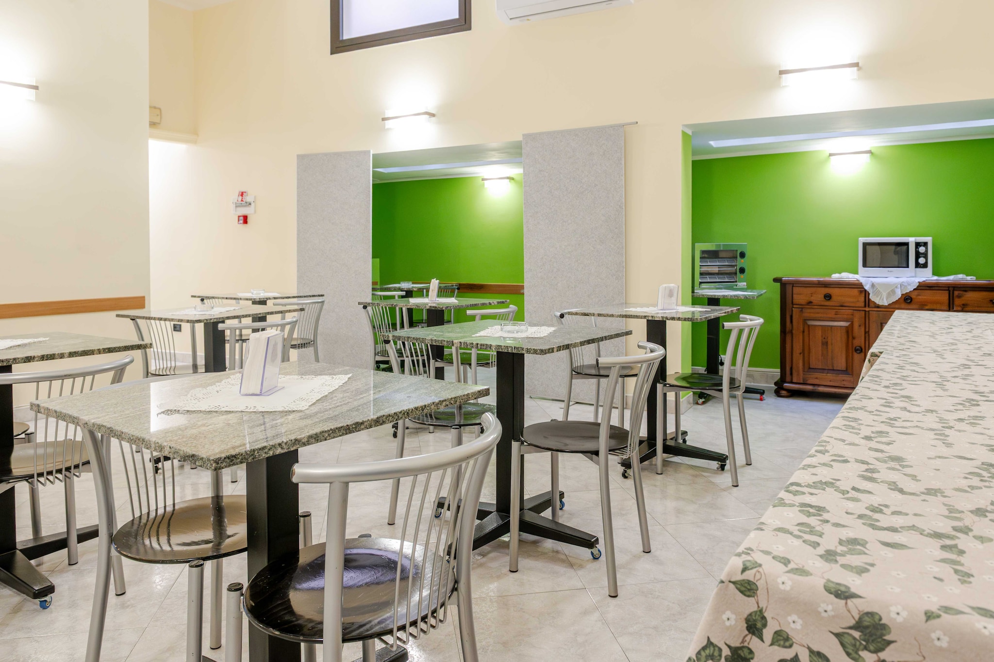 On the 1st floor: (Living/bed room(Bed Linen, single bed, double bed, TV, air conditioning), bathroom(shower, toilet, shampoo))\n\nDesk, Elevator, Hot Water, Internet Access DSL, Safe, Wardrobe, First Aid, Beach, Play area, Breakfast room, electric kettle, coffee machine, microwave, fridge, balcony or terrace, heating, Essentials, Dedicated workspace, Cleaning Disinfection, Downtown, Enhanced cleaning practices, Near Ocean, Room-darkening shades, Town