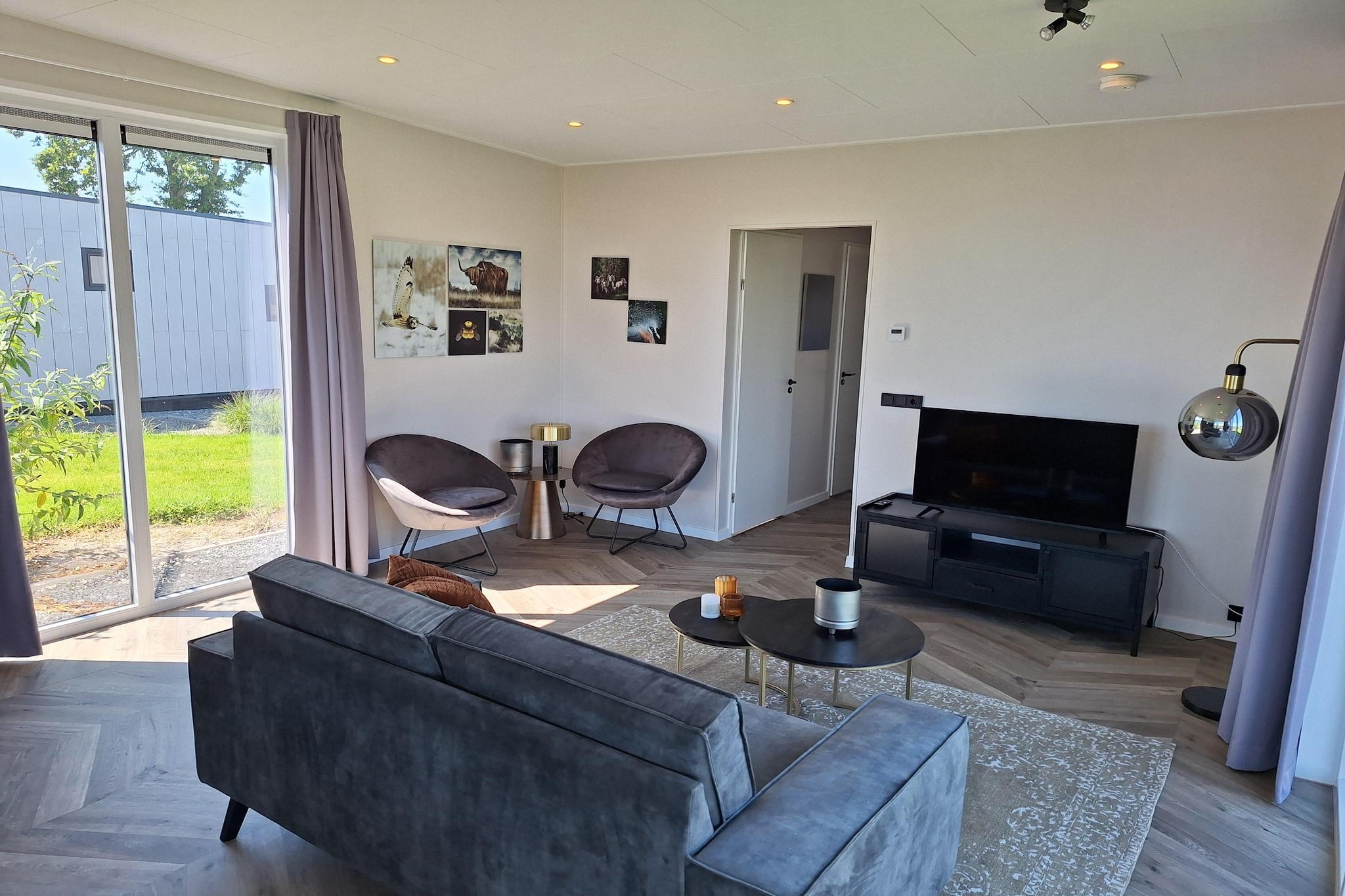 Embrace a stylish retreat in this modern, detached chalet designed to bring the beauty of the outdoors inside. The ground-floor layout is defined by a light-filled, open-plan living area where large windows invite natural light to pour in. The space features a contemporary sitting area complete with a Smart TV, perfect for cozy evenings. Adjacent to the lounge is a fully equipped open kitchen, featuring a gas stove, combination microwave, dishwasher, and even wine glasses, ensuring you have everything needed for a seamless self-catering experience.

The accommodation comfortably sleeps four guests across two serene bedrooms, each thoughtfully furnished with two single beds to provide a flexible and restful sleeping arrangement. A clean, modern bathroom serves the home, equipped with a refreshing shower, washbasin, and toilet. Whether you are traveling as a small family or a group of friends, the home's thoughtful design ensures a sense of space and privacy, all while maintaining a warm and inviting atmosphere.

Outside, the living space extends into a private garden and a fully furnished terrace, complete with a parasol for shaded relaxation. It is the ideal spot to enjoy a morning coffee or an alfresco dinner while soaking in the natural surroundings. Guests also benefit from modern conveniences including free Wi-Fi, a dedicated parking space for one car right at the chalet, and access to a shared swimming pool—offering the perfect balance of private seclusion and resort-style amenities.