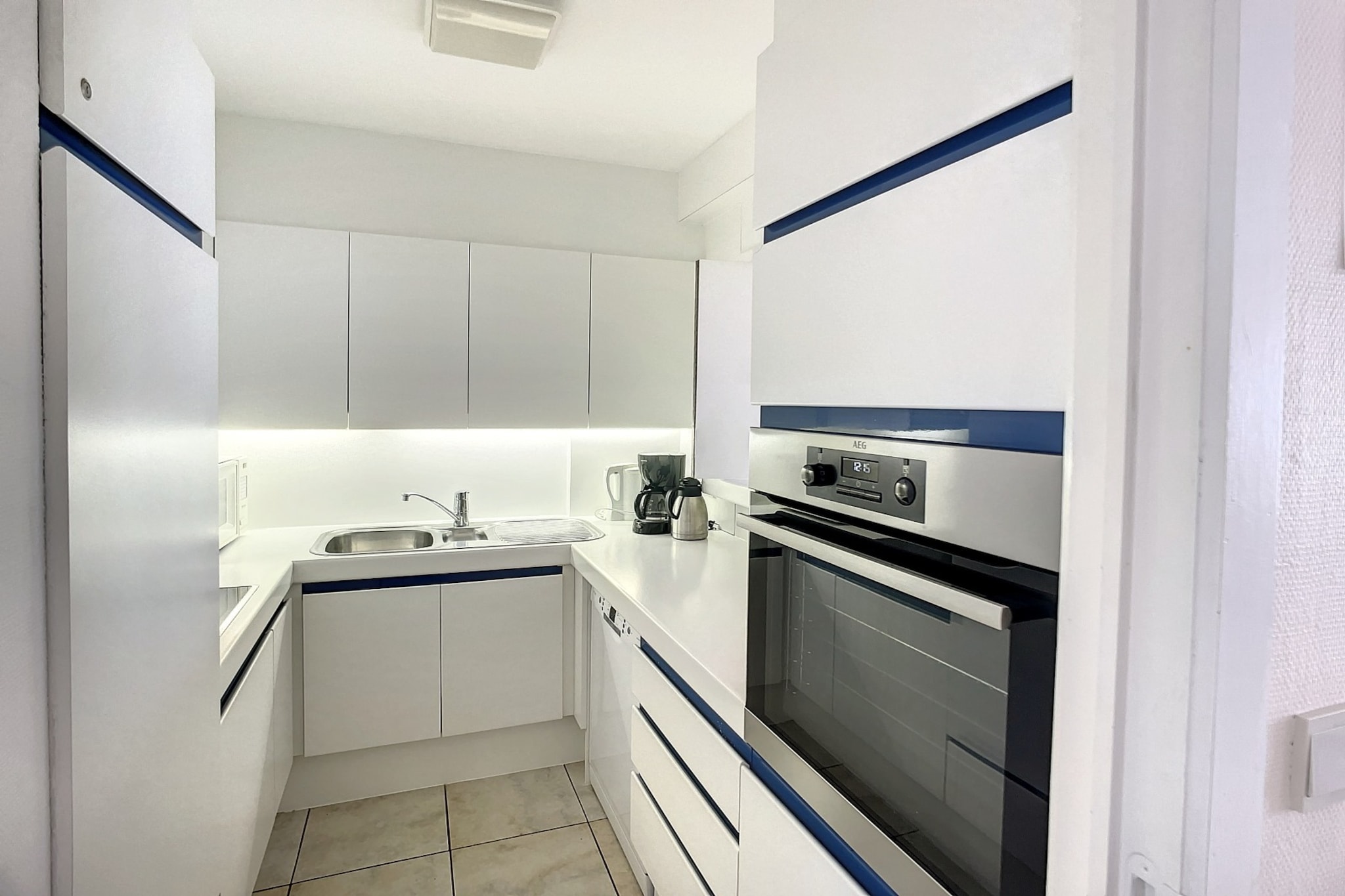 On the 4th floor: (Living room(TV, dining table, seating area), open kitchen(coffee machine(cups, filter), oven, dishwasher, fridge-freezer), bedroom(double bed), bedroom(double bed), bedroom(single bed, single bed), bathroom(bath tub, washbasin), bathroom(shower, washbasin), toilet(toilet, toilet))\n\nwashing machine, parking, ironing board, iron