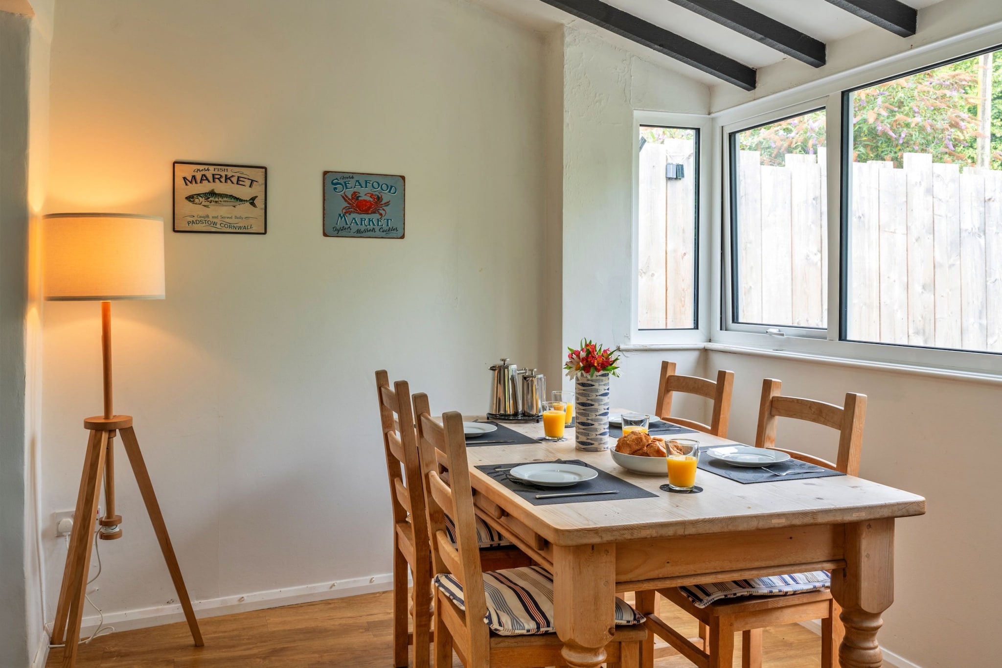 This charming cottage is an inviting retreat that offers a comfortable and homely atmosphere, accommodating up to four guests with two bedrooms—one double and one twin. The cottage is pet-friendly, allowing one well-behaved dog for an additional fee. Inside, the cozy living room features a comfortable sofa, perfect for unwinding after a day at the beach. Guests can enjoy the tranquility of the enclosed courtyard garden, ideal for outdoor relaxation or dining. Additional amenities include Wi-Fi, a Smart TV for entertainment, and a washer/dryer for added convenience.
Nestled in a picturesque Cornish village, the cottage is just a two-minute walk from Porth Beach, where guests can enjoy swimming or take a scenic walk along the Cornish Coastal Footpath. Nearby, the Mermaid Pub offers delicious meals, while the Estrella Morada tapas bar adds a unique touch to the local dining scene. The vibrant town of Newquay is easily accessible, with its shops, cafes, and famous surfing spots. For those seeking further exploration, Padstow, known for its culinary delights, is just a short drive away.
The cottage features a fully equipped kitchen with modern appliances such as a fridge/freezer, microwave, electric oven, and hob, making self-catering a breeze. A family bathroom with a shower and a separate WC on the ground floor add to the convenience. Guests can also make use of the utility room with a washer and dryer, ensuring a comfortable stay for all.