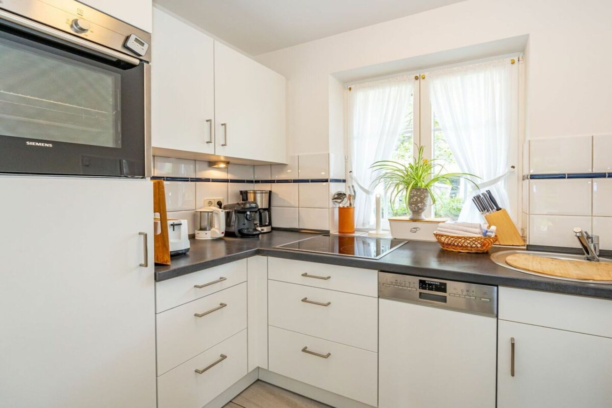 Frisian House "Inselperle im Horsatal"

Bright Frisian house on three levels without a basement.
On the ground floor, a vestibule leads to a tastefully furnished living-dining room, the heart of the apartment, with a sofa corner and a large dining table for 6 people. The property also features underfloor heating, a cable flat-screen TV, a DVD player, a radio, a telephone, and Wi-Fi. A separate kitchen with a ceramic hob, dishwasher, oven, microwave, and refrigerator is available. A guest toilet is on the ground floor, a shower room on the first floor, and a toilet on the second floor.

A Nordic white wooden staircase leads to the upper floor,
where there are two bedrooms and a bathroom.

The master bedroom has a double bed (2 x 90 cm wide), built-in wardrobes, a cable flat-screen TV, and a desk. The smaller bedroom has a French bed (1.50 m wide) and a built-in wardrobe. The bathroom with shower, toilet, and sink has underfloor heating.

Attic with two separate beds (each 90 cm wide) and a toilet with a sink.

One small dog is allowed for a fee.