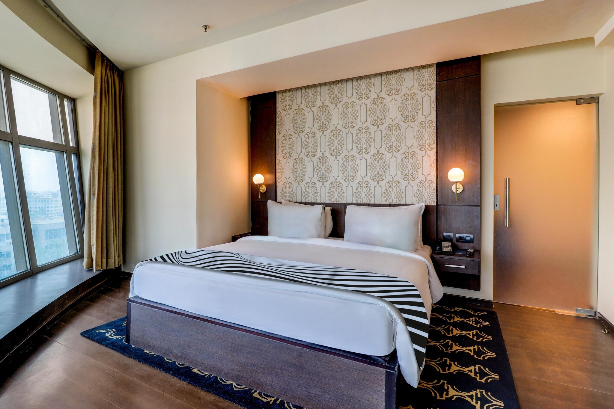 We bring you Luxury Experience by Sunday Hotels Jaipur, Sunday Hotel is first 5-Star property located in C-Scheme, Jaipur. The hotel is centrally located and is only 2 km away from the Jaipur Railway Station and 10 km away from the Jaipur International Airport.
 
The hotel’s 90 rooms and suites are immaculately designed with a host of amenities such as a tea/coffee maker, flat-screen TV with satellite channels, high-speed Wi-Fi connectivity, among others. All Club, Superior & Suite rooms have a bathtub along with a shower cubicle.
 
Restaurants and special amenities
 
For those looking to feast on authentic Rajasthani dishes or relish Indian, Continental & Chinese cuisine, they can dine at our restaurant The Sunday Diner and bar The Sunday Spirit. Our guests can also enjoy authentic Rajasthani, Continental, or Chinese cuisines at our restaurant The Sunday Diner or enjoy a refreshing drink at the bar "The Sunday Spirit". Our Chef’s Signature preparations would make your stay with us truly memorable.
 
Kickstart your day with a workout at our fully-equipped fitness center. Or take a dip in the pool and visit our spa for a relaxing massage, which is guaranteed to restore your natural glow.
 
The hotel also has a business center and 2 banquet halls, ideal for occasions ranging from formal meetings to elaborate weddings. The spacious ballroom for 150 guests is perfect for hosting conferences and private events.
 
Nearby attractions
 
Sunday Hotel is under 15 minutes drive from Jaipur’s major tourist attractions spots like Hawa Mahal, Jantar Mantar, City Palace, Famous Sawai Mansingh Indoor cricket stadium and ESIC office is just 500 mtrs from our hotel in SEO. Being part of the mall gives easy accessibility to recreational activities and any retail therapy one desires in a shopping arcade."

Unmarried couples are warmly welcome at this property.
Guests with local ID proof are warmly welcome.
Early Check-In Policy: A full day’s room rate will be charged for check-ins before 6:00 AM. Complimentary early check-in is available between 6:00 AM and 10:00 AM, subject to room availability.
Check-in is only available to guests aged 18 and above. Please provide a government-issued ID to confirm your age.