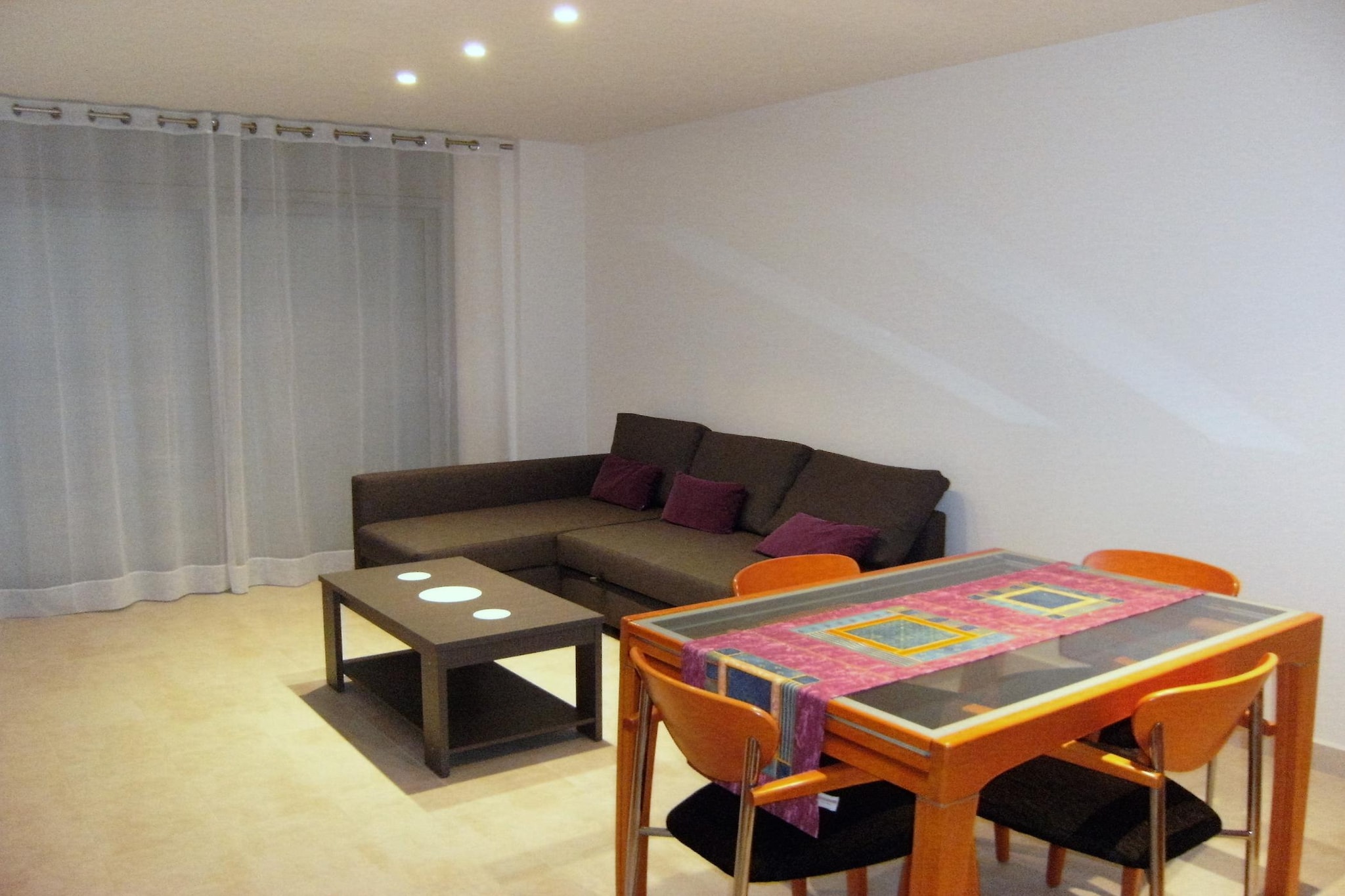 This comfortable 65 m² apartment accommodates up to four guests, featuring two well appointed bedrooms. Located in the city center, it offers a peaceful residential atmosphere with easy access to local attractions. The property is not pet friendly and includes essential amenities such as Wi Fi, air conditioning throughout the house, a heat pump, a washing machine, an iron, and a TV. Guests can enjoy a private balcony with outdoor furniture, as well as access to a communal swimming pool with a childrens section. An elevator and open-air parking within the same building provide added convenience.

Ideally positioned, the apartment is just 200 meters from the sandy beach, making it an excellent choice for a relaxing seaside retreat. A supermarket is only 150 meters away, while the city center is just 100 meters from the property, offering a variety of shops, restaurants, and entertainment options. Golf enthusiasts can visit the EMPORDA GOLF CLUB, located just 6 km away. With its prime location, guests can enjoy the perfect balance between a lively urban environment and a relaxing beachside atmosphere.

The independent glass ceramic kitchen is fully equipped with modern appliances, including a refrigerator, microwave, oven, freezer, and dishwasher. Essential dishes, cutlery, and kitchen utensils are provided, along with a coffee machine, toaster, and juicer for added convenience. A well maintained washroom ensures comfort, making this apartment an excellent choice for families or small groups seeking a stylish and centrally located vacation home.