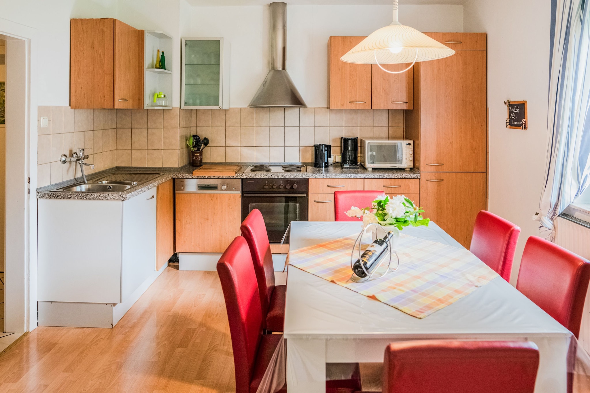 Ground floor: (hall, Living room(DVD player, radio, stereo unit), Large kitchen(dining table(6 persons), electric kettle, toaster, cooker(4 ring stoves), coffee machine(filter), oven, microwave, dishwasher, fridge(+ freezer)), bedroom(double bed(boxspring, 180 x 200 cm)), bedroom(single bed(90 x 180 cm), single loft bed(90 x 180 cm)), walk-through bedroom(double bed), bathroom(bath tub, shower, washbasin, toilet))\n\nski storage, carport, TV(flatscreen, satellite), stove, bathtub or shower, balcony, heating(central, oil), garden, garden(shared with the owner ), bicycle storage, garden furniture, BBQ, BBQ(charcoal), parking, parking, deckchairs, parasol, play equipment, children\'s bed, children\'s bed, high chair, party games