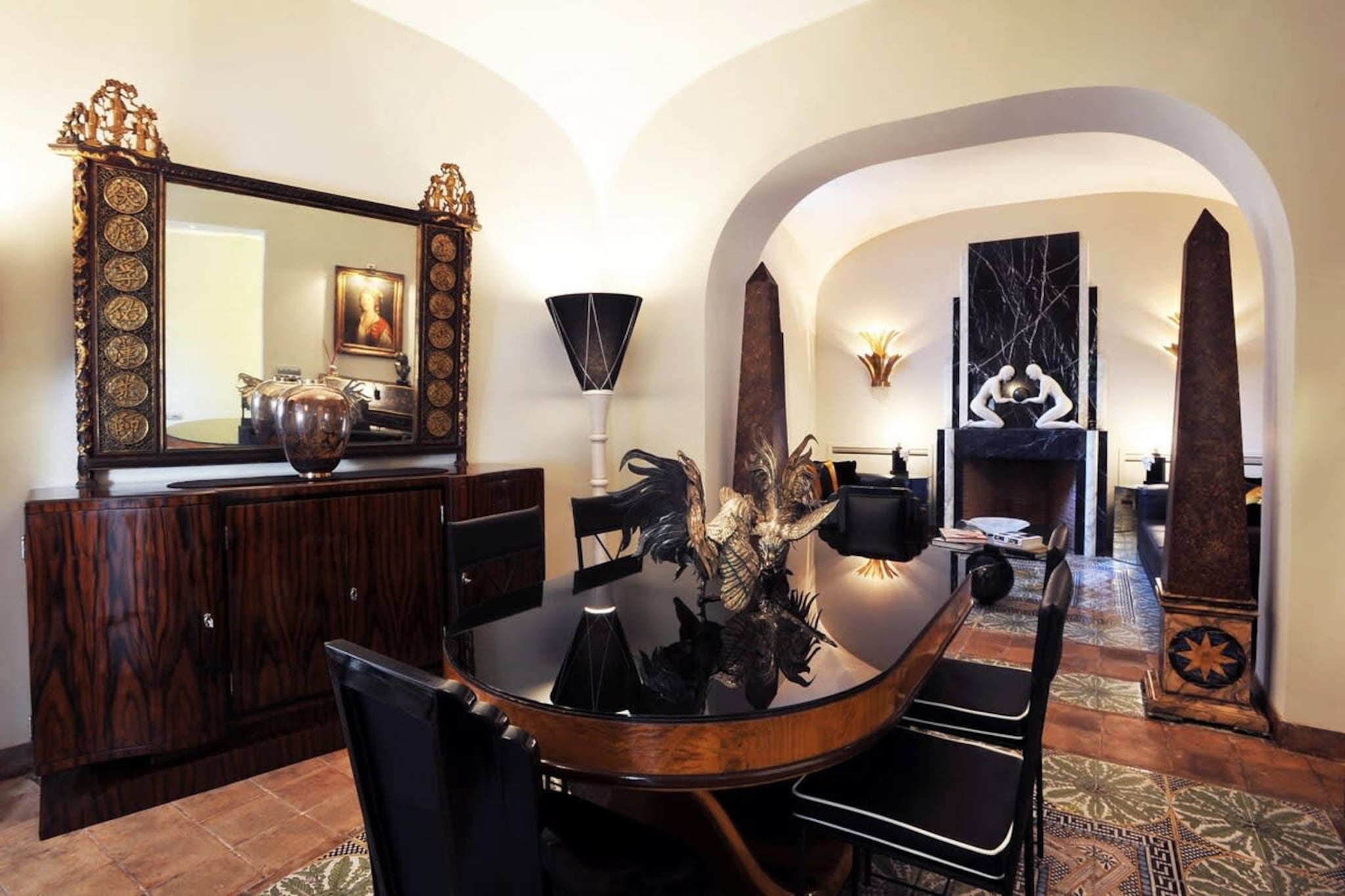Tucked away in the heart of Trastevere, La Palazzina Santa Dorotea is a rare gem that offers guests a truly cinematic Roman experience. This elegantly restored two-bedroom townhouse, owned by a renowned Italian film producer, is filled with striking artwork, rich textures, and a dramatic flair that blends Art Deco glamour with timeless Italian charm. Step inside and be immersed in a world of curated beauty—every detail, from the ebony furnishings to the sculptural lighting, has been chosen to impress and inspire.
The living and dining rooms are masterfully styled, offering intimate corners for conversation, quiet reading, or candlelit dinners. The two plush bedrooms each feature luxurious ensuite bathrooms, providing comfort and privacy in equal measure. French doors open to a private courtyard garden and a sunlit terrace—ideal for outdoor dining or a morning espresso beneath the Roman sky. Whether you’re celebrating a romantic occasion or simply seeking a distinctive escape, this private retreat delivers the charm of a palazzo in a wonderfully intimate setting.
Located just steps from Piazza Trilussa and the banks of the Tiber, the townhouse is surrounded by the energy and elegance of Trastevere, known for its cobbled lanes, stylish boutiques, and vibrant food scene. A short stroll across Ponte Sisto brings you to Campo de' Fiori and Rome’s historic center, placing the best of the city at your fingertips. With optional chef service and absolute privacy, La Palazzina Santa Dorotea is the perfect base for an unforgettable Roman holiday.