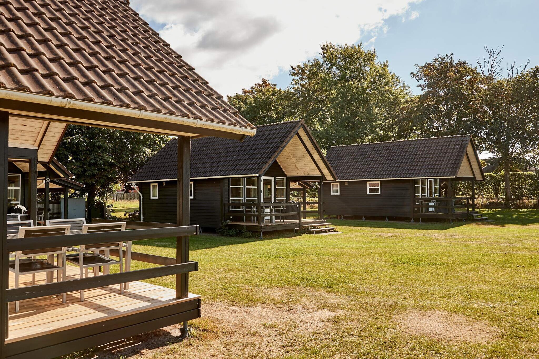 Kitchen(cooker(electric), coffee machine, fridge(+ freezer)), Living/bed room(single folding bed, TV), bedroom(double bed, bunk bed), bedroom(2x single folding bed), bathroom(washbasin, shower, toilet), heating(central), terrace, garden furniture, sun loungers, parking, play equipment