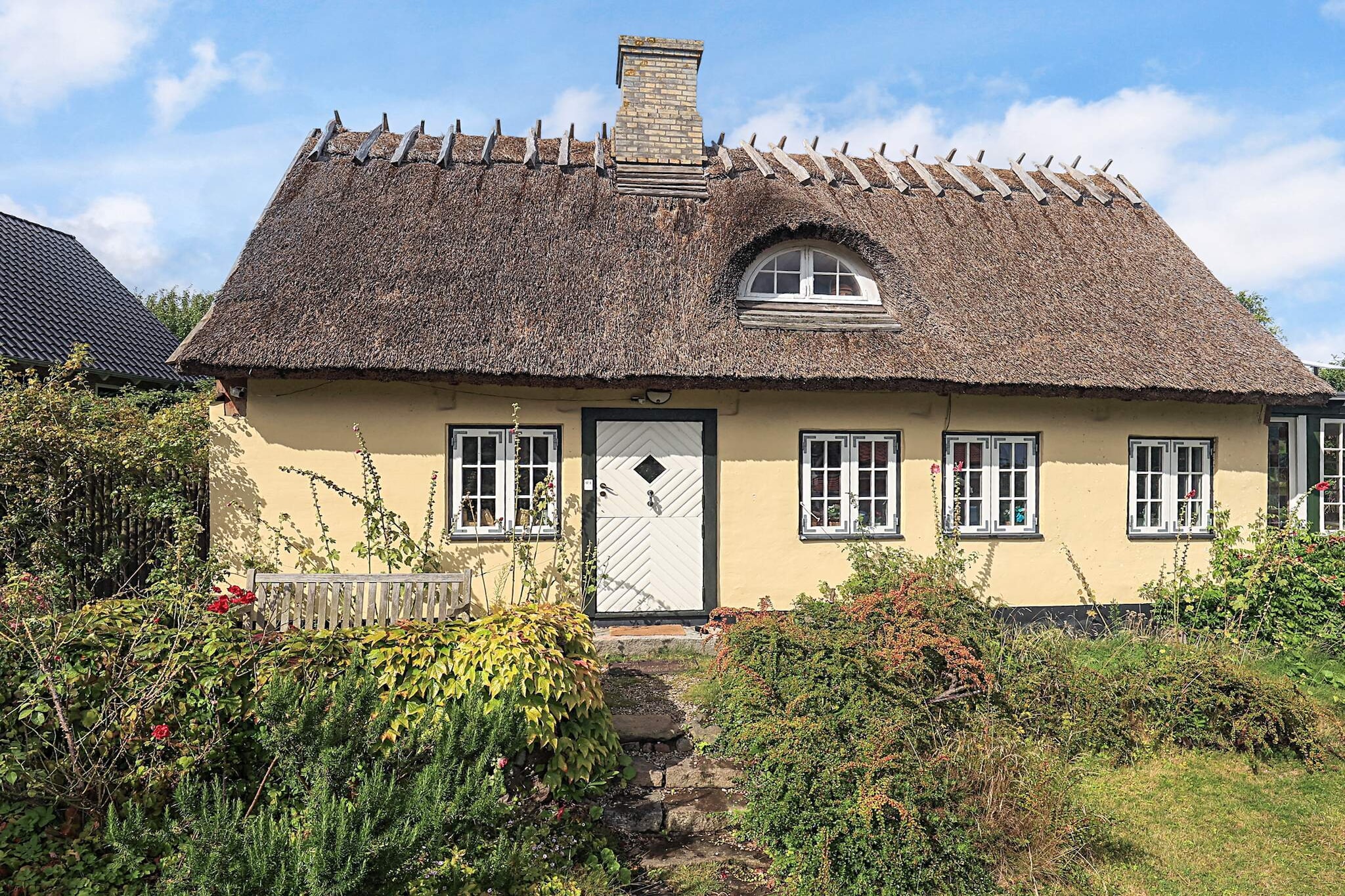 Charming, older house with plenty of soul and character – perfect for a relaxing holiday surrounded by beautiful nature. The large garden offers plenty of opportunities to enjoy the outdoors, with a charcoal grill and two terraces where you can dine in the open air. Here you will find peace, relaxation, and the unique charm of a house with history. The house is located in Sletten, an old and idyllic fishing village surrounded by forest and sea. A short walk takes you to the beach, where you can listen to the gentle sound of the waves, while the nearby forest invites you to peaceful walks accompanied by birdsong and lush greenery. The area is perfect for nature lovers who appreciate fresh sea air, quiet strolls, and the special atmosphere of a historic coastal village. The accommodation sleeps up to six people, with one bedroom with a double bed, a connecting room with two single beds, and another connecting room with a sofa bed (double). There is a well-equipped kitchen, a bathroom, a cosy living room, and a bright conservatory – ideal for enjoying a glass of red wine by candlelight. Guests have access to the entire house as well as an outbuilding with a washing machine and dryer. A charcoal grill and bicycles are available, making it easy to combine relaxation with small local adventures.A refundable deposit might be charged closer to your check-in date. The security deposit ensures a smooth stay and covers any additional services or consumption charges.This deposit covers utilities consumed during your stay and any additional services that may be taken.The final amount will be adjusted based on actual meter readings, actual usage of extra services, and any remaining balance will be refunded within 21 days after checkout.This deposit simply acts as a prepayment for charges that  you would anyways pay for, ensuring a seamless stay and check-out experience.