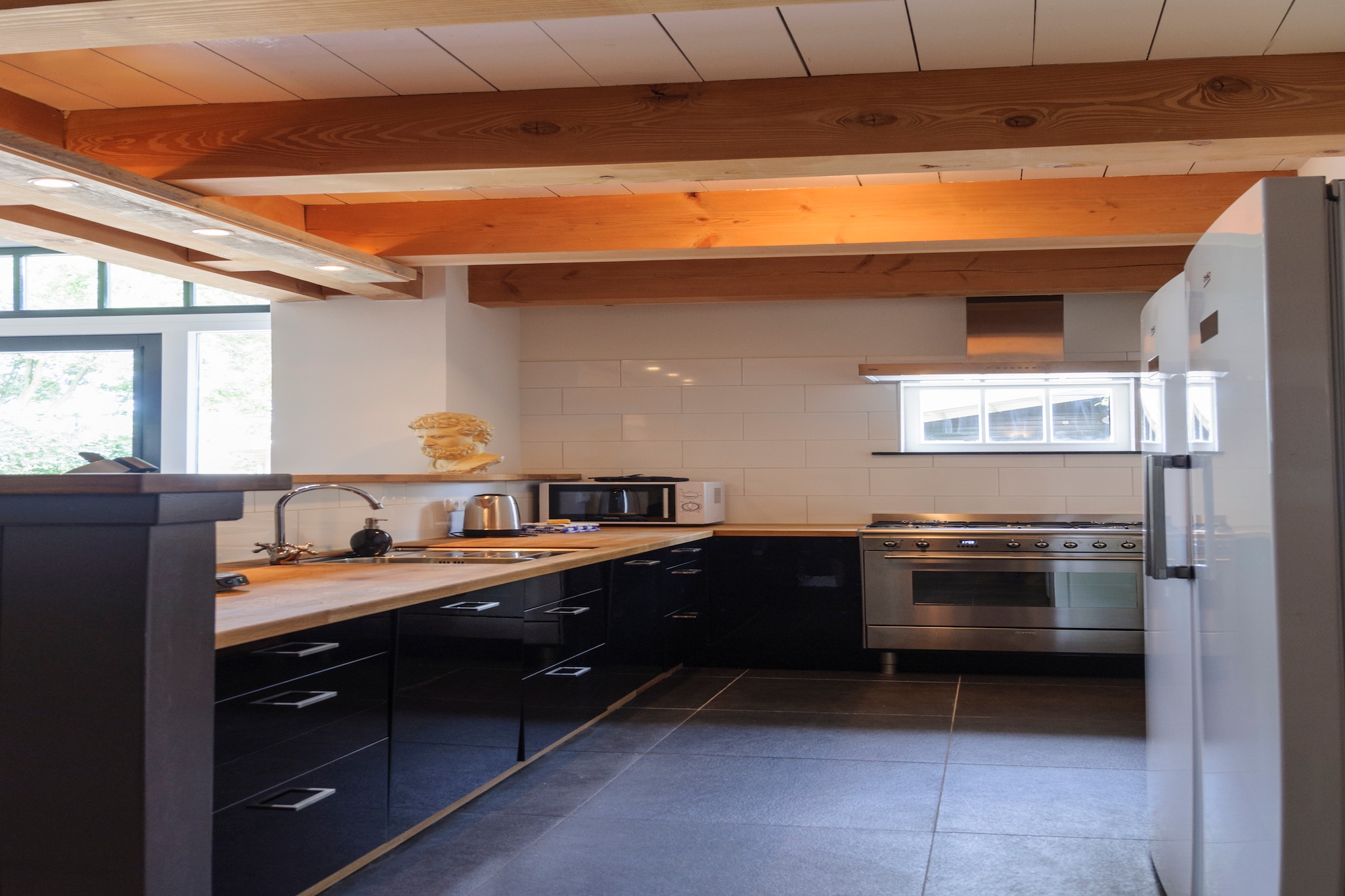 In the peaceful coastal village of Callantsoog, this spacious farmhouse offers the perfect getaway for up to 22 guests. Ideal for large families or groups of friends, it combines space, comfort, and a touch of rustic charm. Inside, youâ€™ll find a welcoming living area, a large dining space where everyone can gather, and a generously equipped kitchen that invites shared cooking and long meals together.

The house is designed with both connection and relaxation in mind. On the top floor, a cosy lounge with panoramic windows opens up to sweeping views over the dunes, the village, and the Het Zwanenwater nature reserve and on clear days, even the sea. Multiple bathrooms and thoughtfully furnished bedrooms ensure that everyone has their own comfort, while still enjoying the joy of staying under one roof.

Outdoors, the farmhouse offers wide green spaces where children can play freely and adults can unwind. Garden furniture invites you to sit back with a morning coffee, gather for an afternoon chat, or enjoy a barbecue as the sun sets. Within walking distance, youâ€™ll find Callantsoogâ€™s charming village square, sandy beach, and local restaurants, while nature lovers can set off on hikes or bike rides straight from the doorstep. A place made for laughter, shared meals, and unforgettable moments perfect for creating memories together.